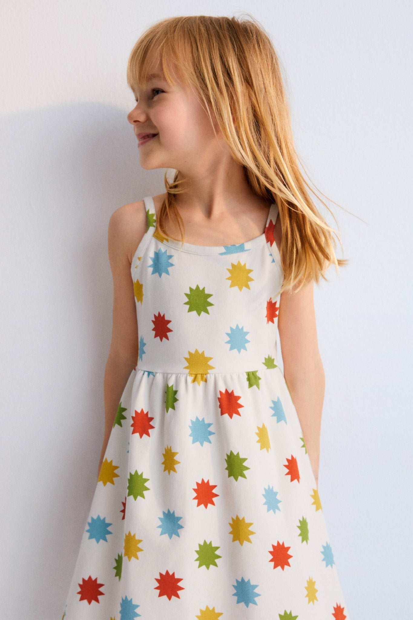 Short jersey dress with multicolored star print, spaghetti straps, and gathered waist. New Collection. Spring Summer. The New Society.