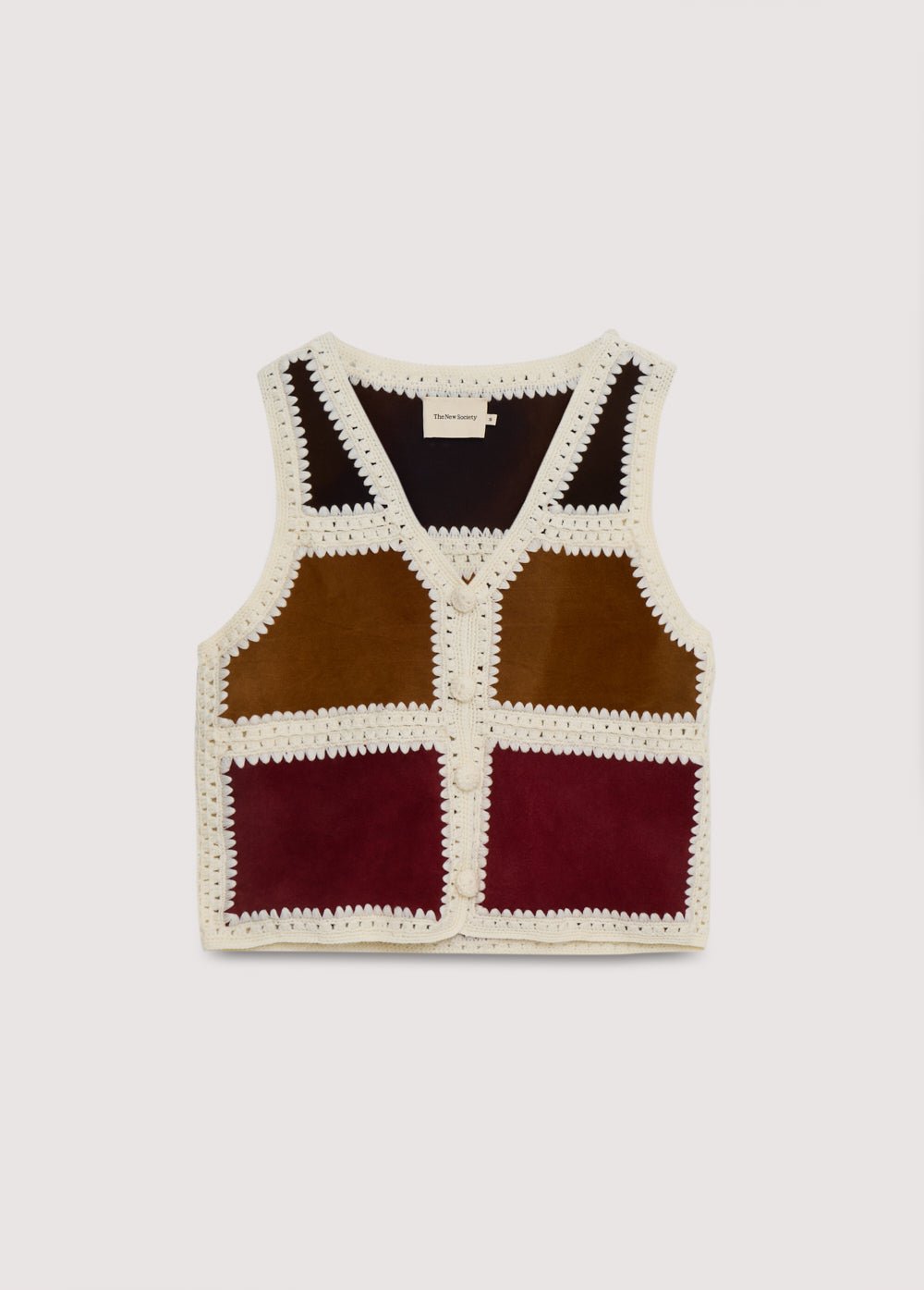 Ce gilet est une pièce spéciale fabriquée en Espagne, confectionnée à partir de cuir de différentes couleurs et de laine tissée à la main au crochet. Une pièce parfaite à associer avec la jupe assortie.
