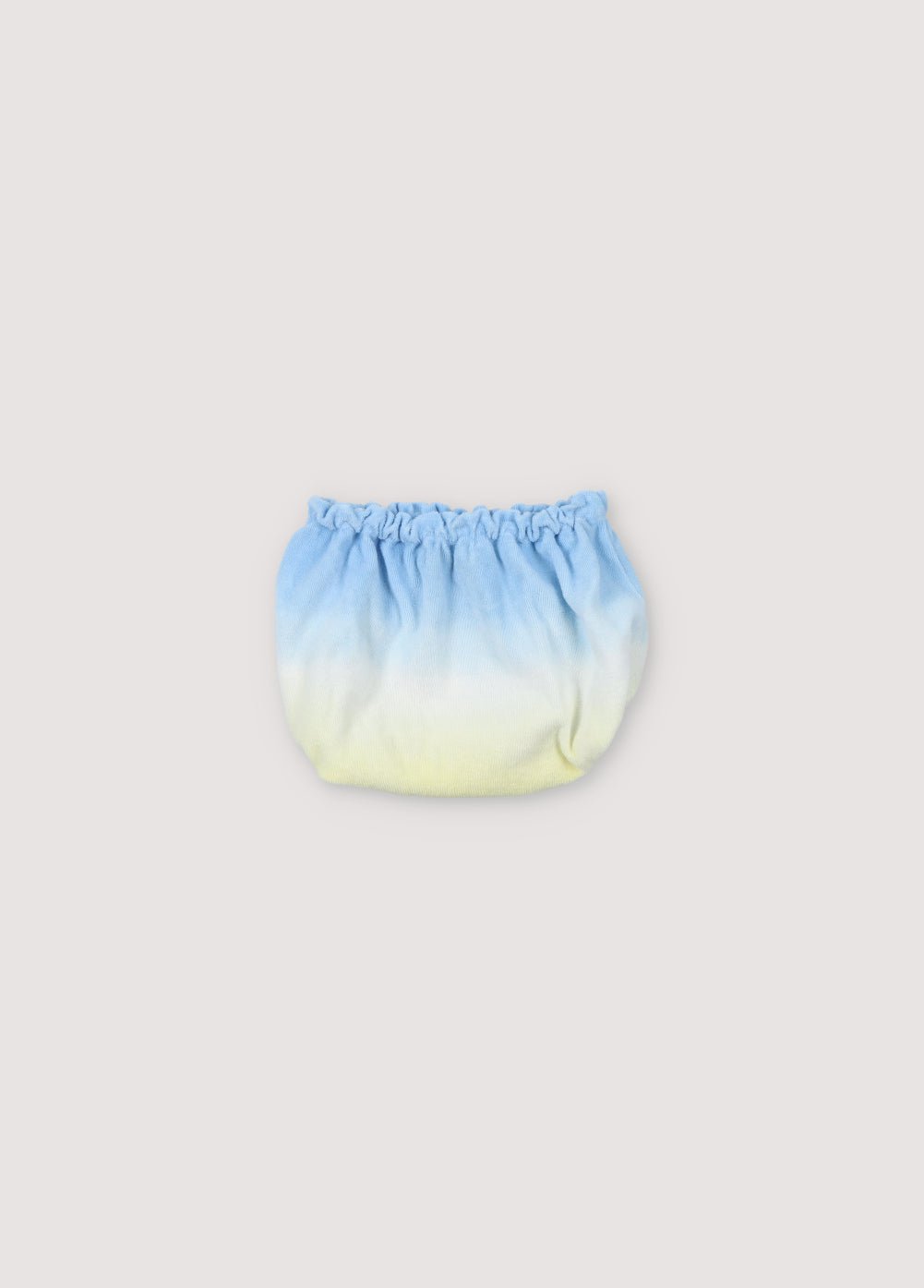 Bloomer pour bébé en tissu éponge avec effet tie-dye et jambes et taille élastiques pour un effet froncé. Parfait à combiner avec le T-shirt assorti de la collection Printemps Été. The New Society.