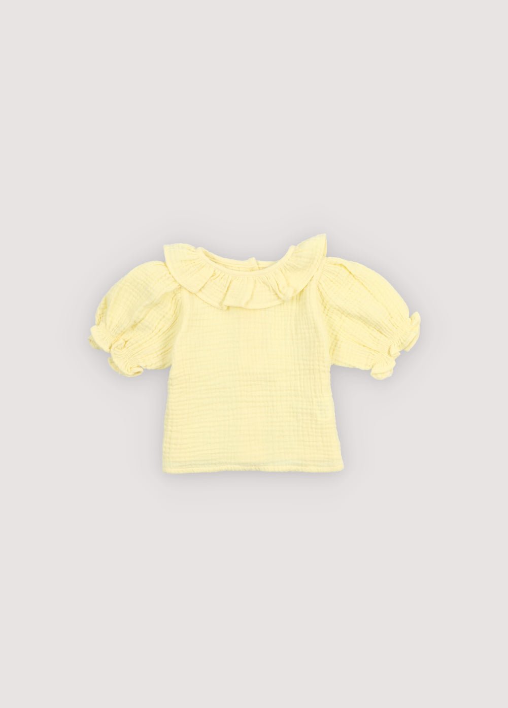 A soft cotton gauze blouse designed for everyday comfort and effortless style. Features elasticized, ruffled cuffs and a delicate neckline detail for a charming finish.