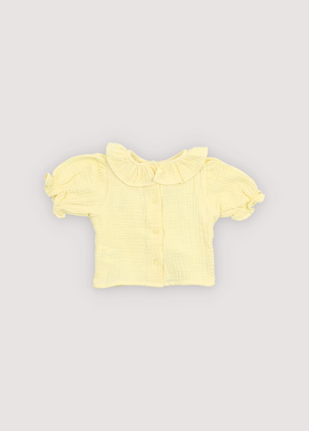 A soft cotton gauze blouse designed for everyday comfort and effortless style. Features elasticized, ruffled cuffs and a delicate neckline detail for a charming finish.