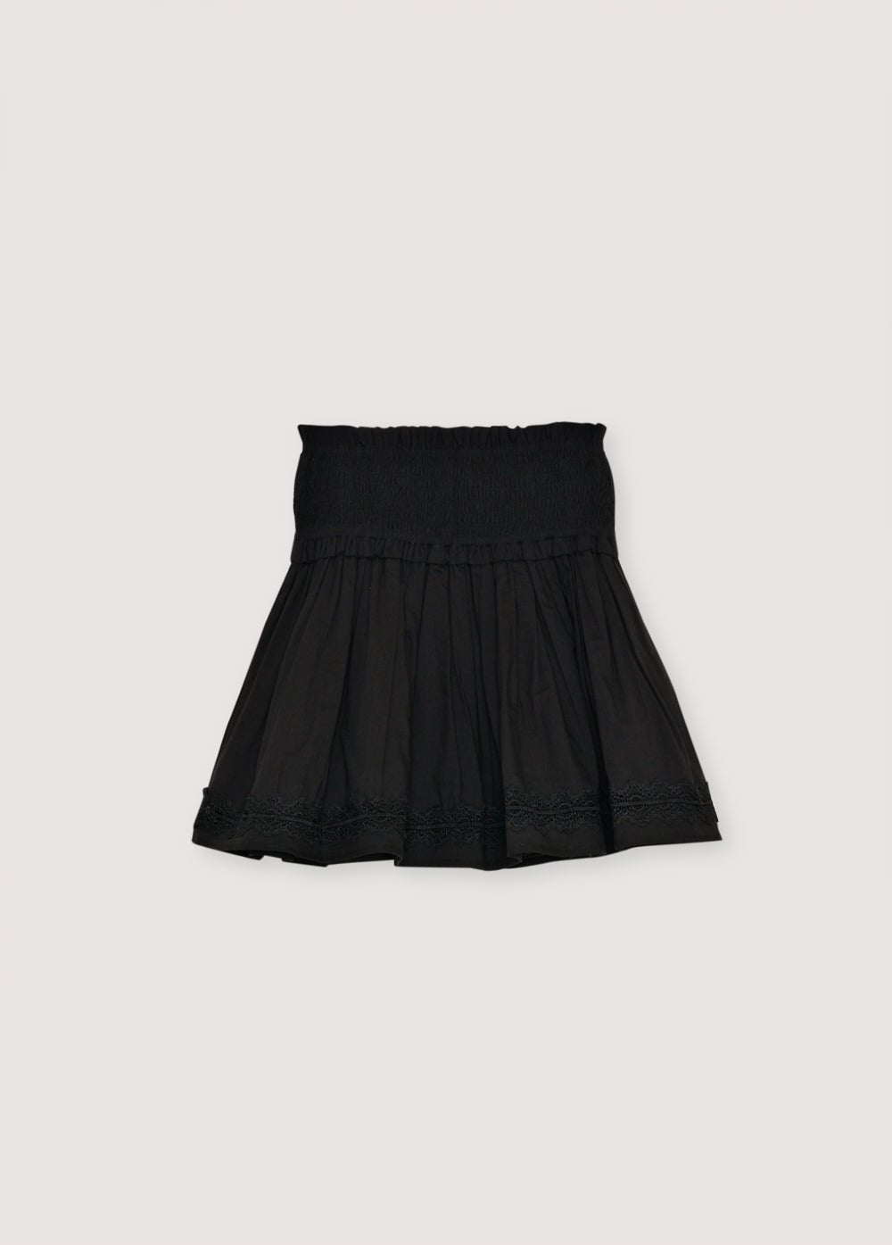Falda de gasa de algodón con detalle fruncido en la parte superior y bajo con volante y ribete de encaje. Perfecto para combinar con la blusa a juego.