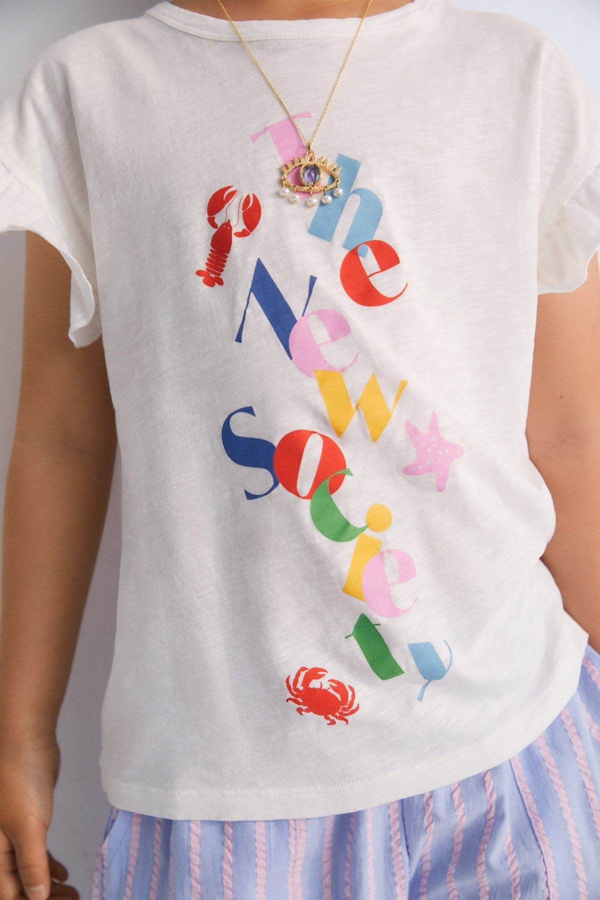 Flame T-shirt with ruffles on the sleeves and a playful brand print on the front.
