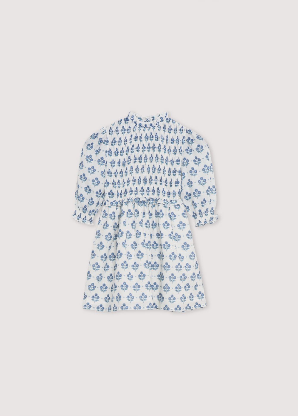 Eleni Dress in 100% cotton muslin fabric with our hyacinth print. The dress features a square neckline with smocking all over, puffed sleeves with smocking and a final ruffle, and a skirt with lots of volume.