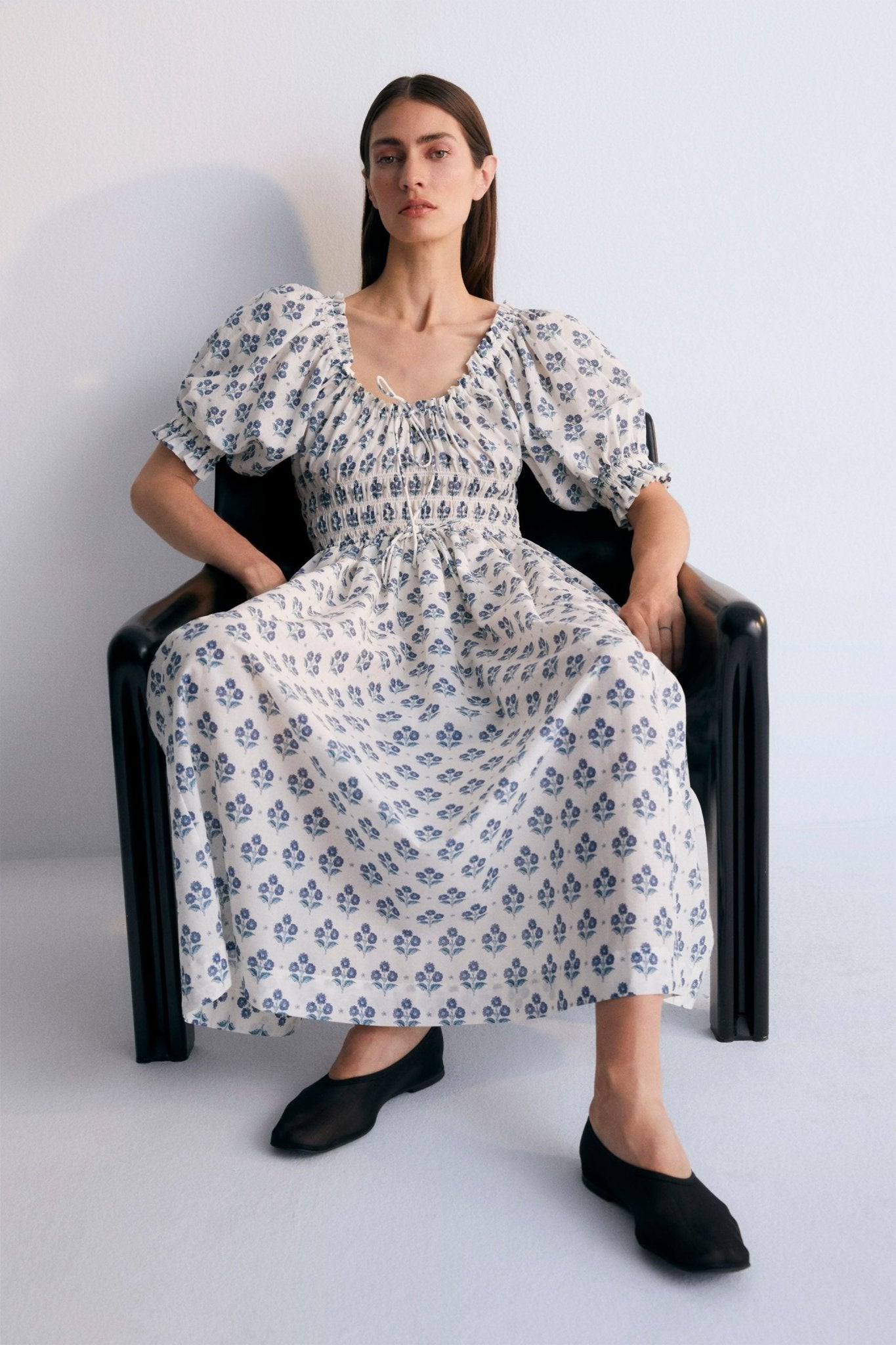 Eleni Woman Dress, our bestseller now featuring our Hyacinth print in 100% cotton poplin fabric. V-neck, elasticized, puff sleeves, and midi length. Spring Summer Collection. The New Society.