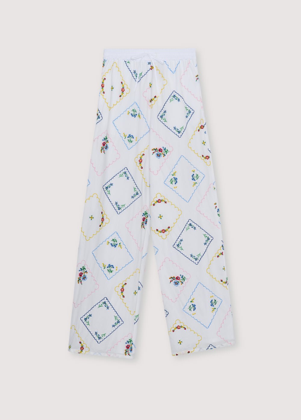 Pantalones confeccionados en suave tejido de algodón con bordados florales multicolores que crean un look delicado y vibrante.