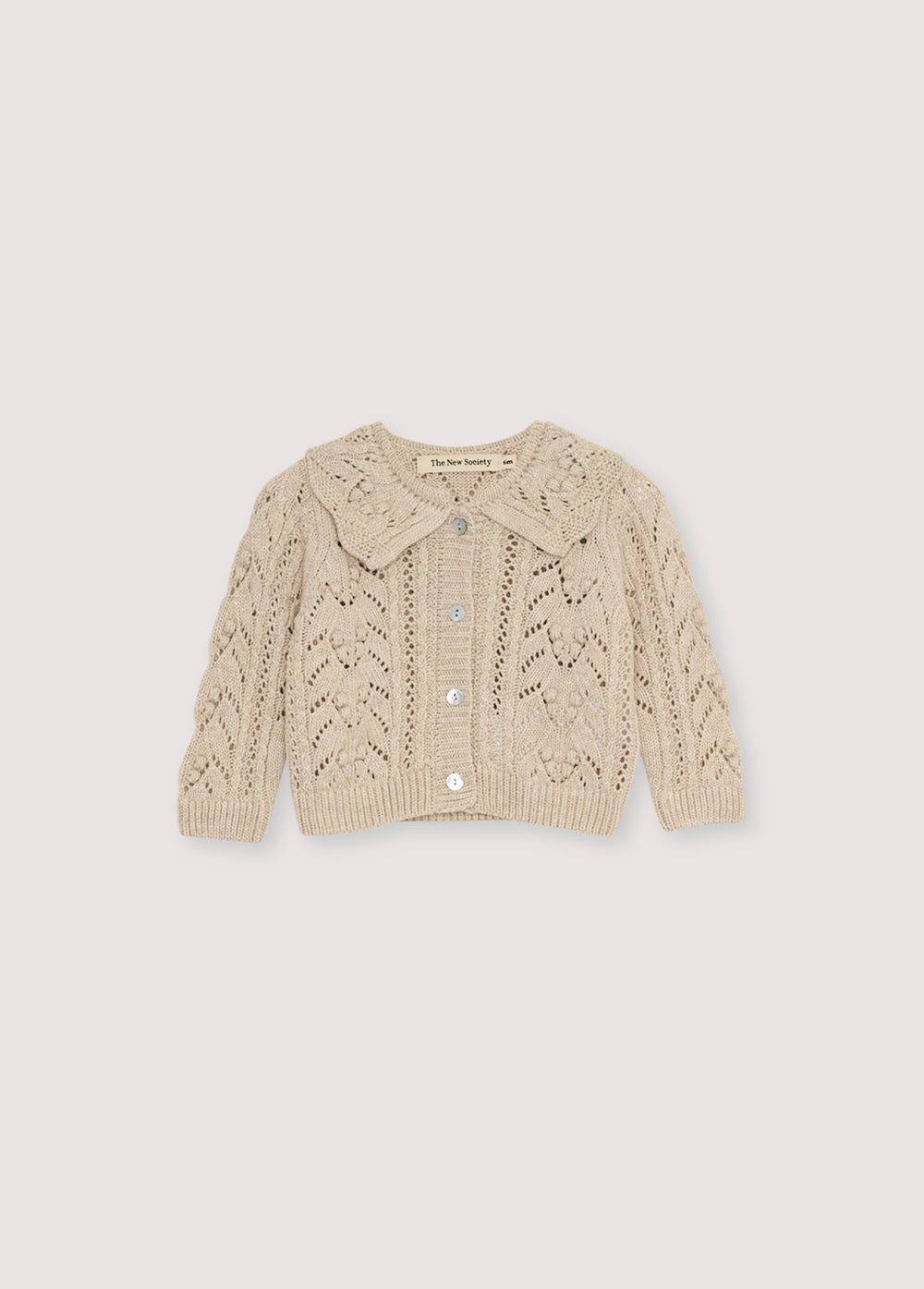 Cashmere and wool all recycled cardigan with a beautiful knit design and a ribbed collar detail. It features a front opening with mother-of-pearl buttons. It comes with matching leggings to create a beautiful complete look.