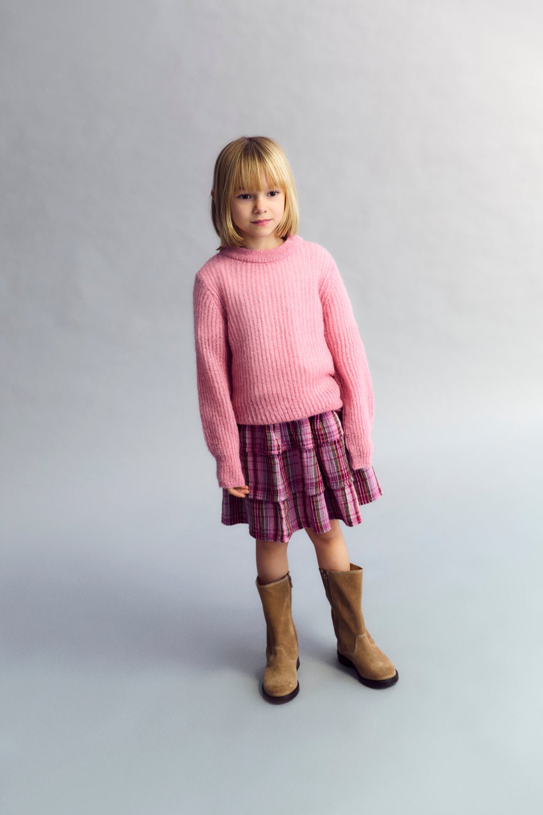 Fine rib knit mohair sweater with a round neckline and ribbing at the neck, cuffs, and hem. It feautures a TNS embroidery on tone on hem rib.
