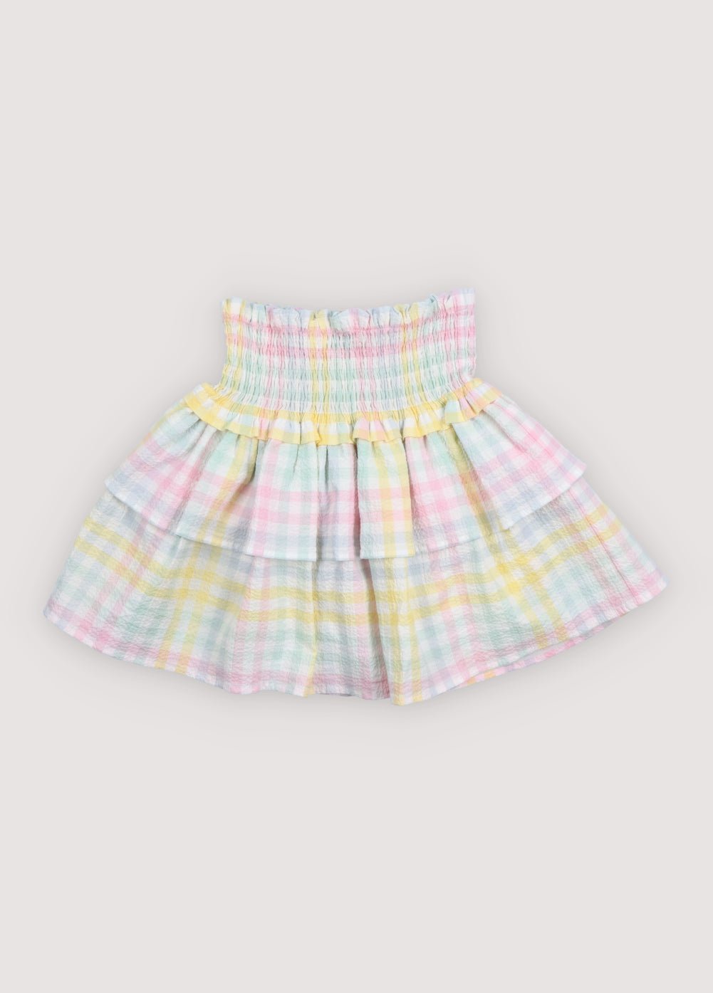 Our classic skirt pattern in cotton seersucker with multicolor checks, featuring smocking at the top for a comfortable fit and a double ruffle that adds movement and charm