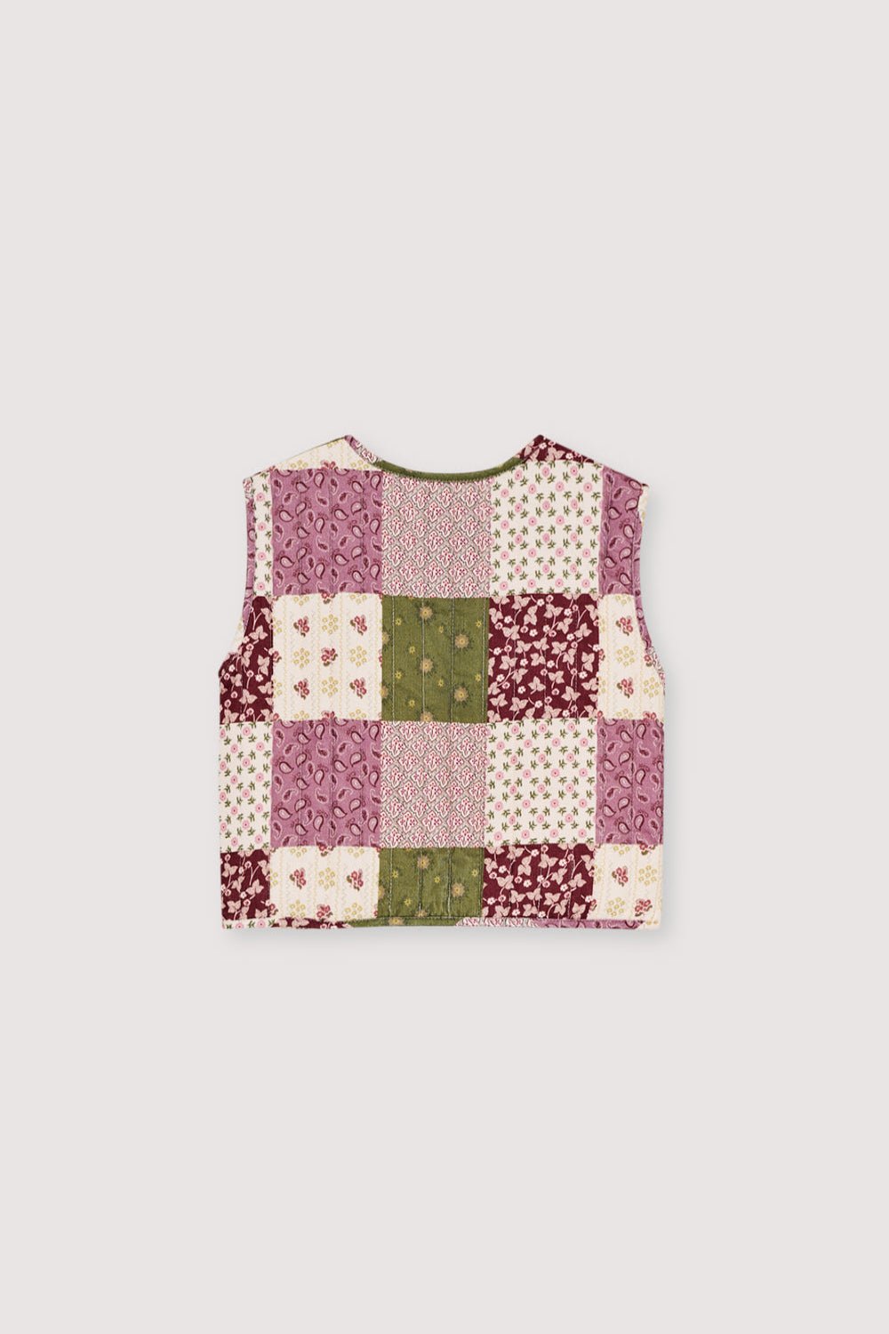 Quilted Micro-Corduroy Vest
Featuring a unique patchwork print, this vest has a front closure with both tie and button details for a charming finish