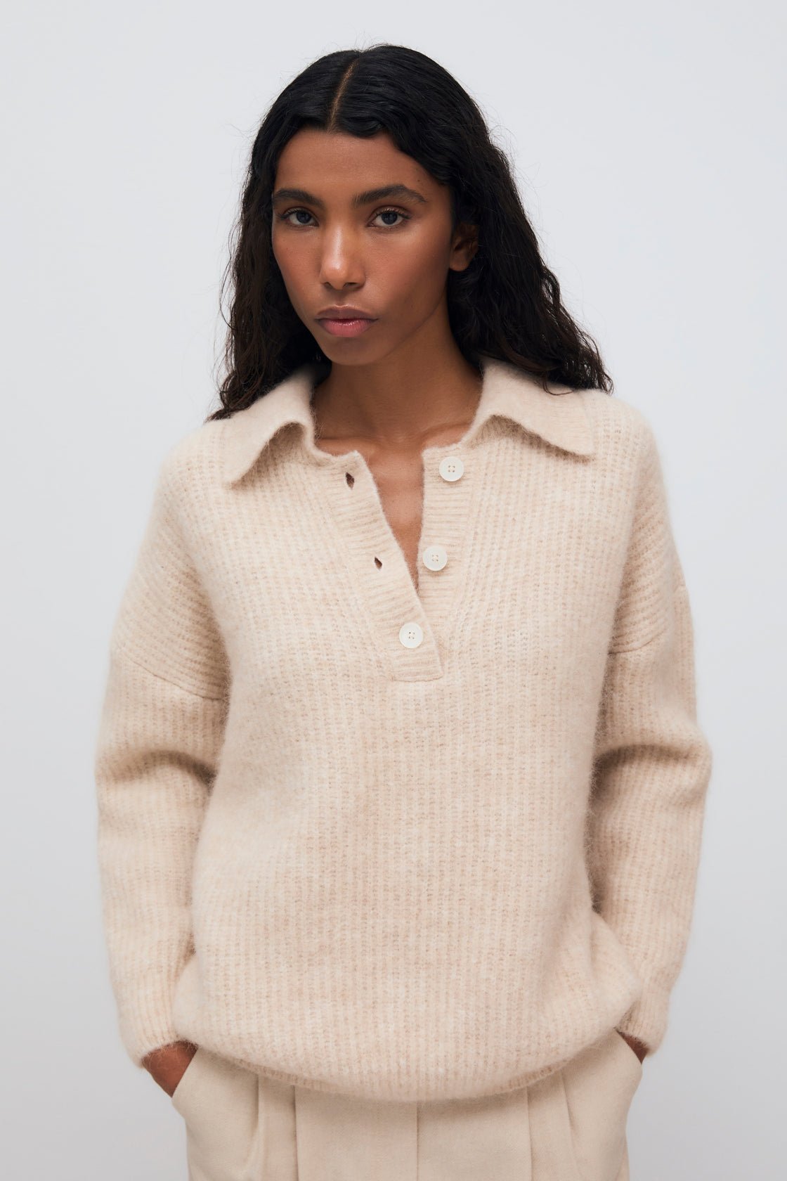 Wool knit polo crafted in exquisite quality, featuring a front placket opening with beautiful buttons in tone.
