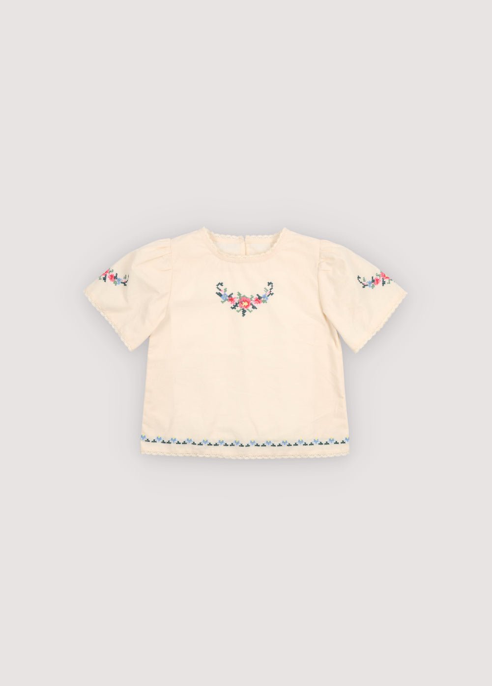 Blouse in soft cotton featuring beautiful fine embroidery details on the front and sleeves, adding a delicate and refined touch