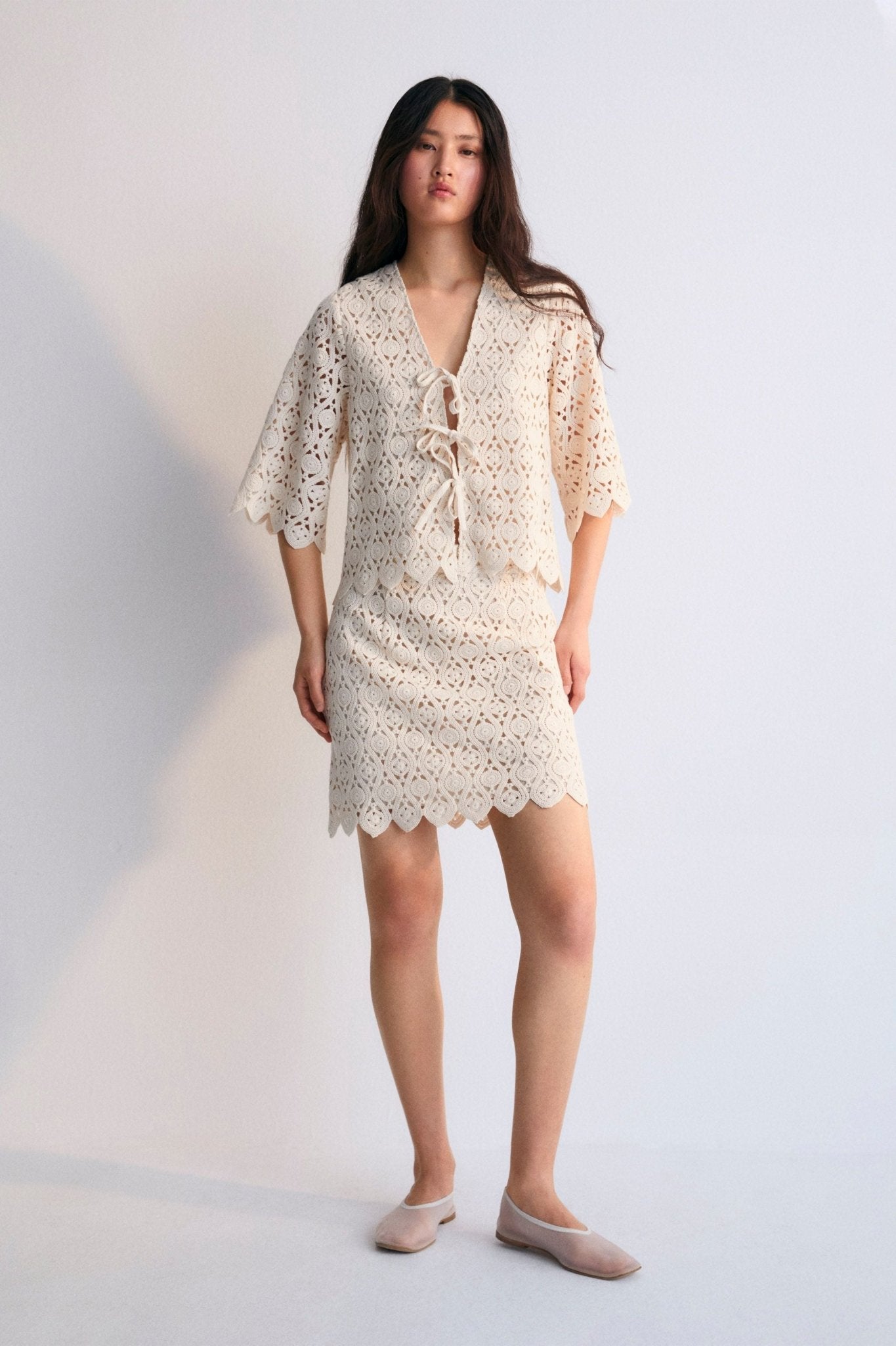Crochet skirt with inner lining and side slit with invisible zipper. Perfect for creating a coordinated look with the matching top. Spring Summer Collection. The New Society.