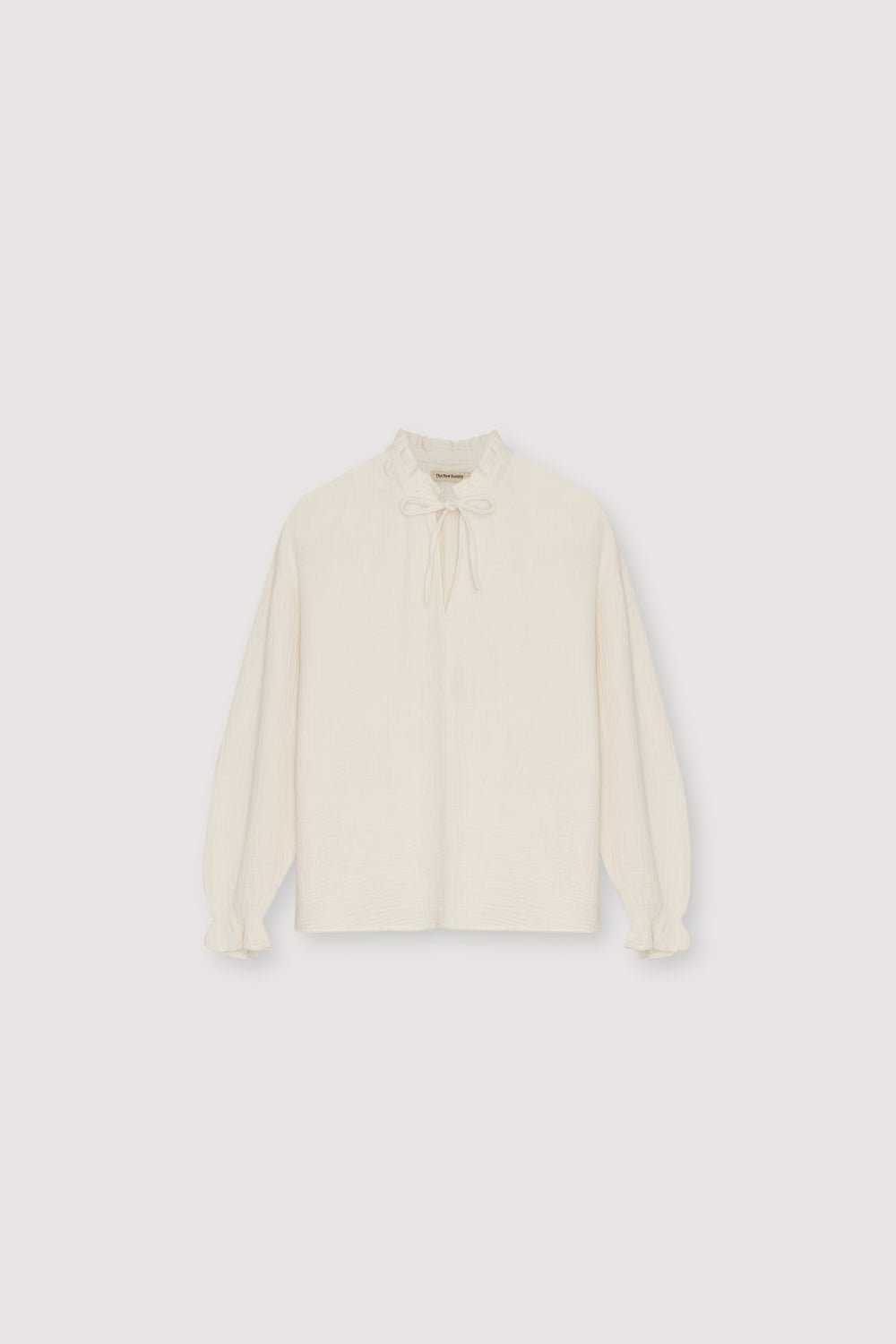Our classic Olivia Blouse, made from double gauze fabric. It features puffed sleeves and a front keyhole detail with a tie.