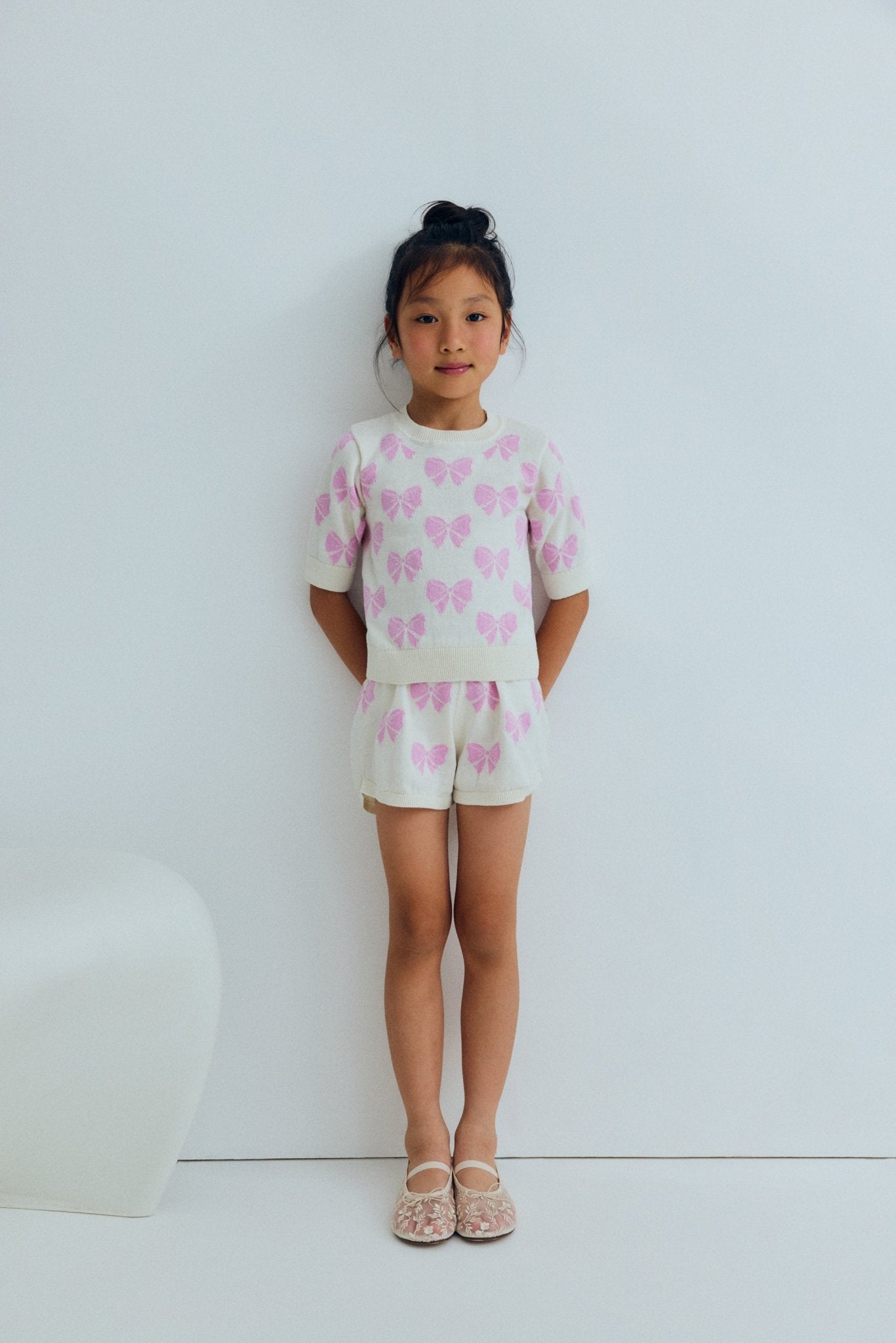 One of our bestselling sets: a fine 100% cotton knit jumper adorned with delicate pink bows and finished with ribbed hem, collar and cuffs.