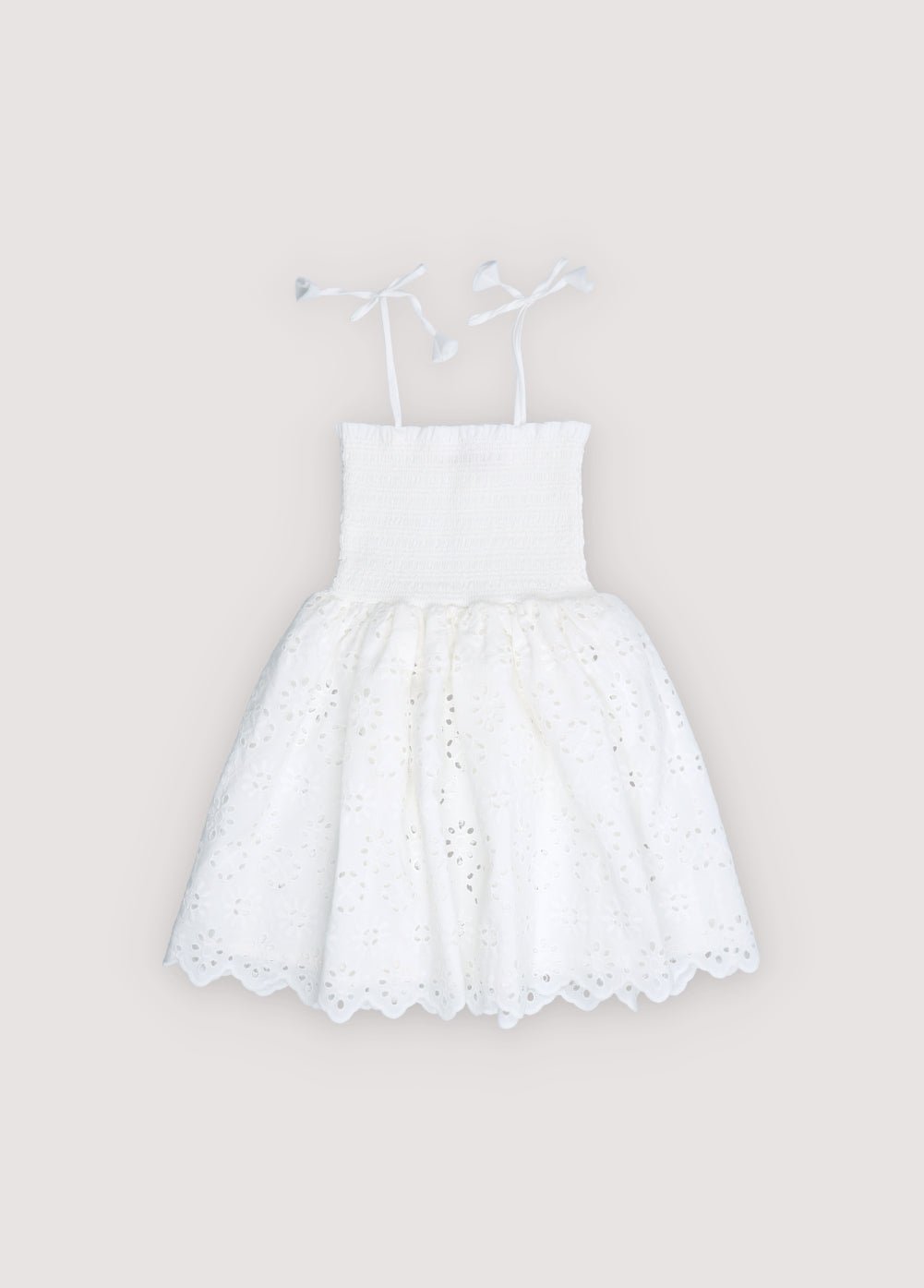 Short dress in beautiful embroidered cotton fabric, featuring a smocked bodice with ruffle detail for a comfortable and flattering fit.