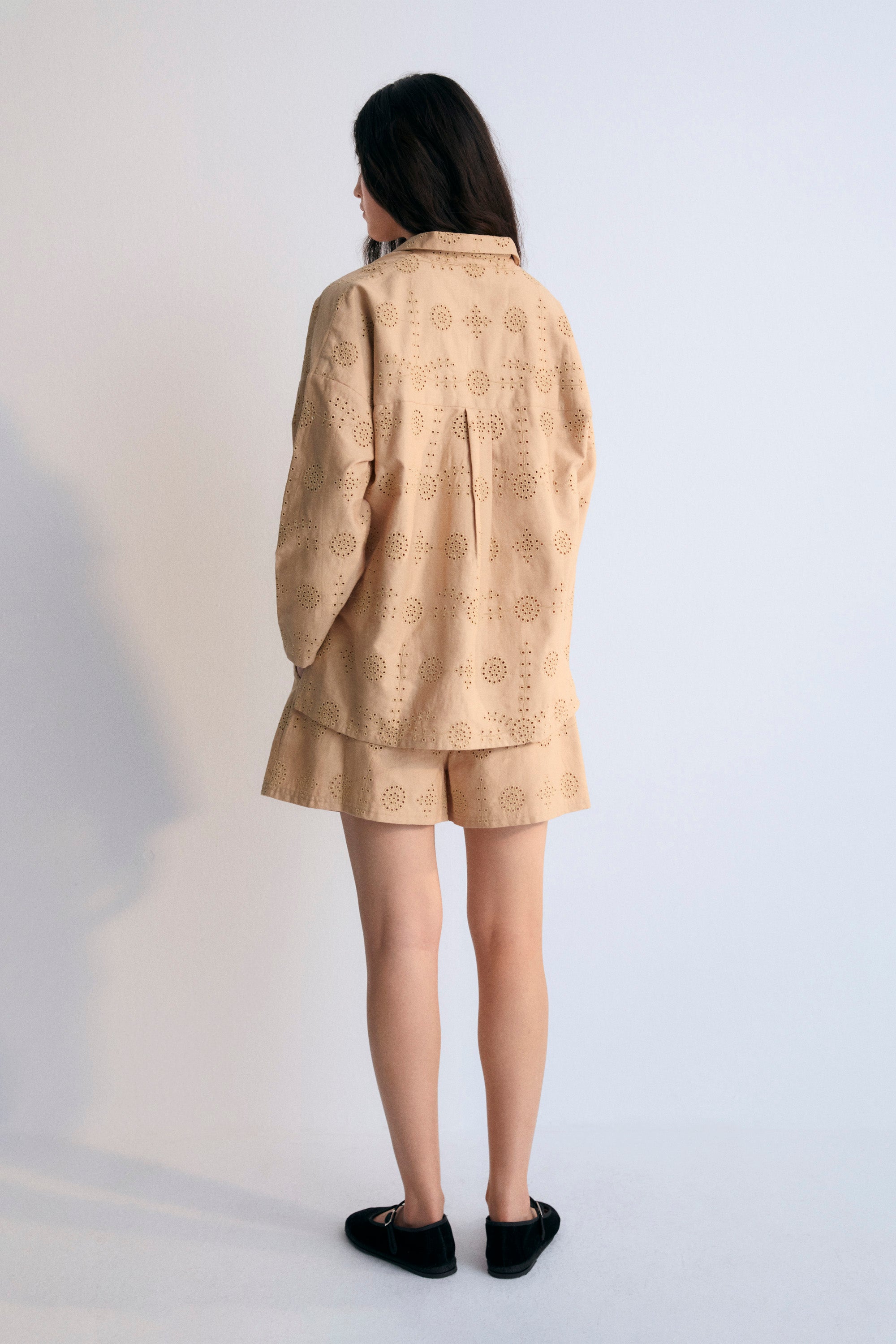 This polo-style shirt is adorned with delicate tone-on-tone embroidery, adding a subtle yet refined touch to the classic design. The intricate details elevate the traditional polo, making it a perfect blend of casual sophistication. Ideal for creating a polished yet relaxed look.