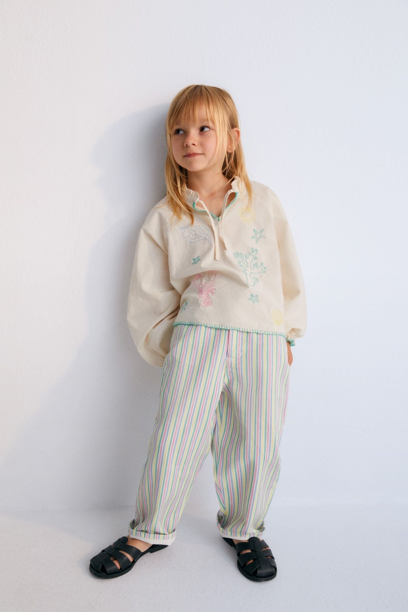 Denim trousers with a colorful multicolored stripe print and an elastic waistband at the back. Spring Summer Collection. The New Society.