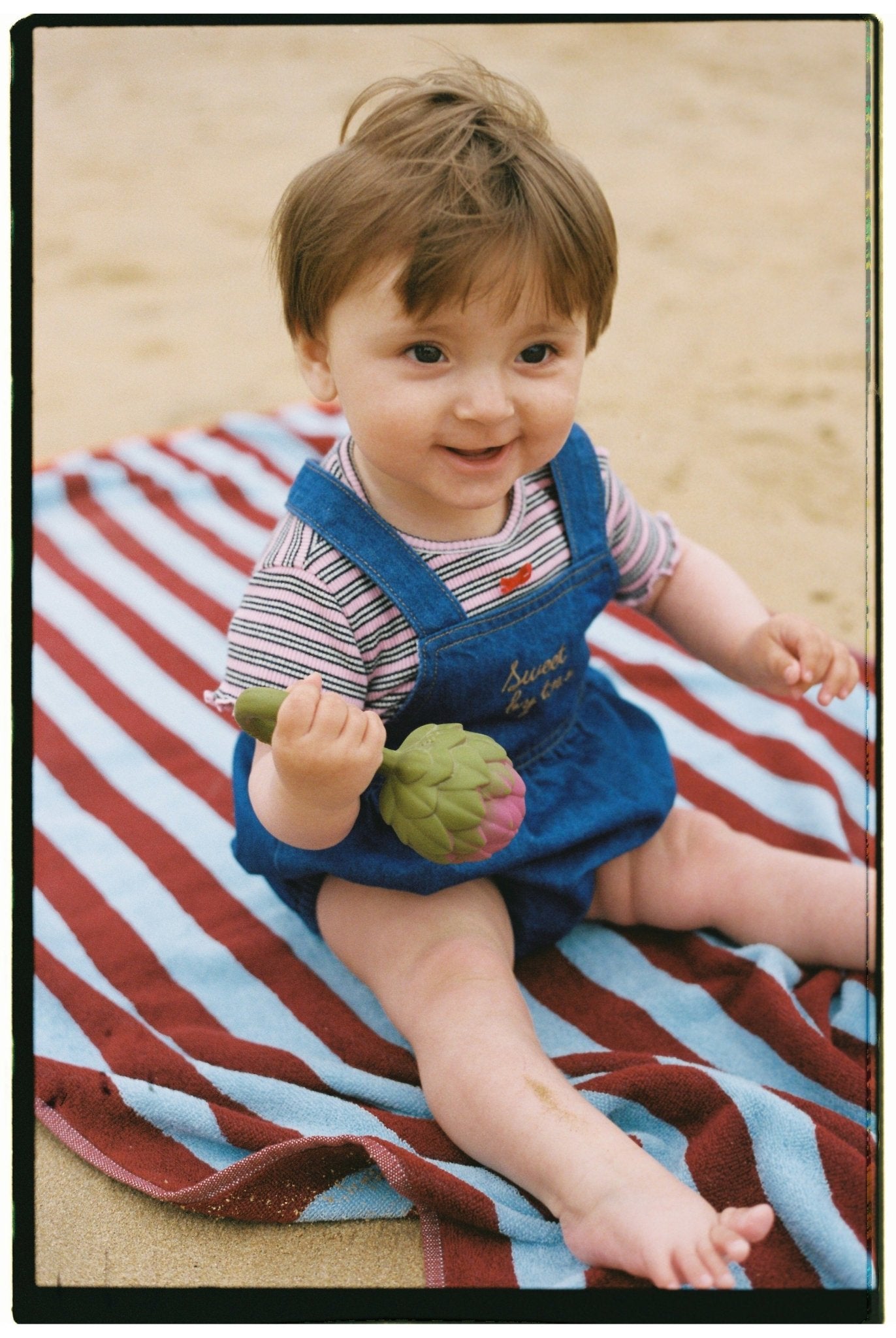 Baby romper crafted from 100% cotton denim.