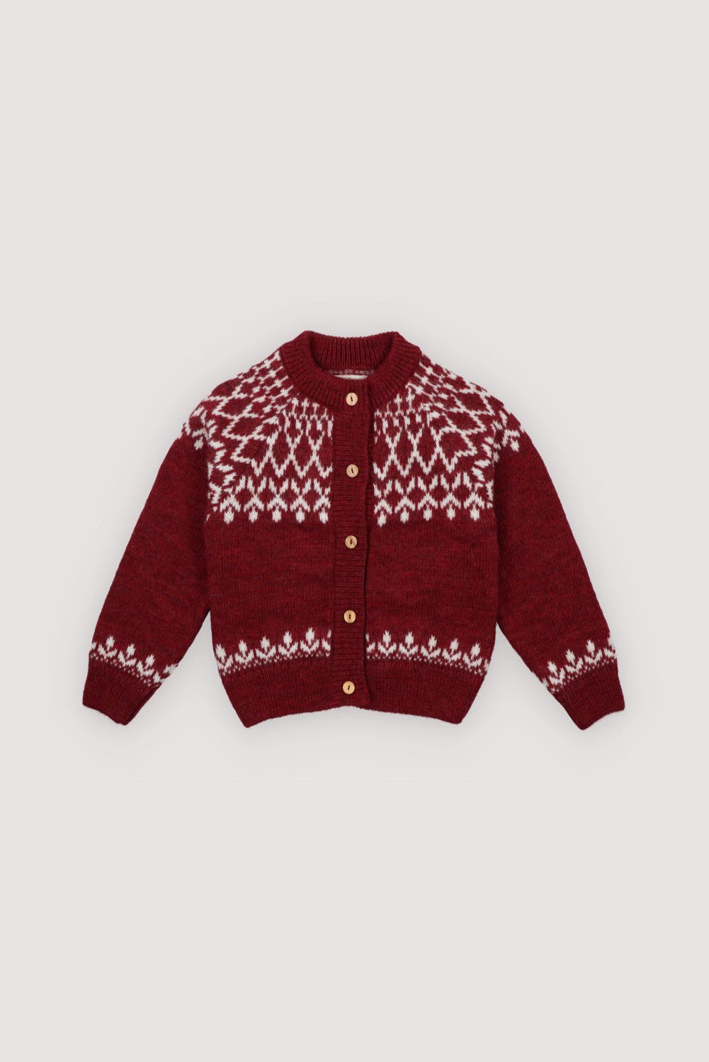 A cozy knitted cardigan in a festive plum color, featuring a charming white pattern across the chest, sleeves, and hem. Soft, warm, and gently stretchy, it keeps little ones comfortable all day. Designed with a front button closure and a relaxed fit, it’s perfect for easy dressing and playful movement. Ideal for holiday gatherings or capturing seasonal memories in style.
