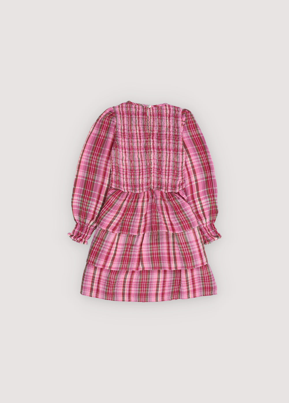 A charming special dress crafted from soft checkered double gauze, featuring a smocked bodice and an elasticated fitted waistband for a comfortable, flattering fit. The skirt is adorned withn ruffles, and the back opening includes a teardrop cut with a button closure, adding a subtle, elegant detail.
