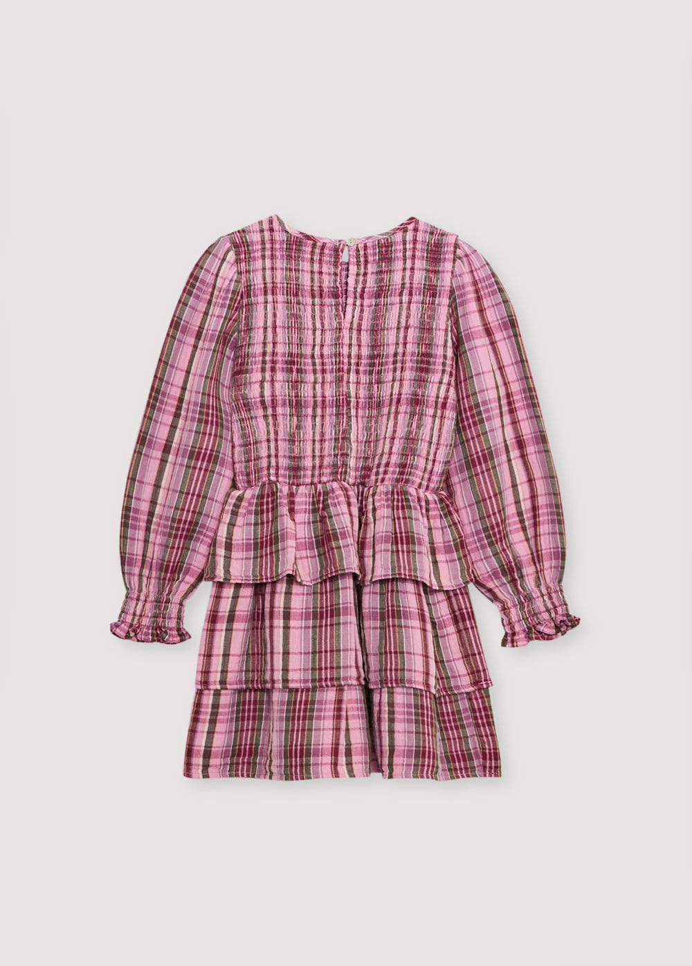 Short checkered double gauze dress with a smocked bodice, elasticated fitted waistband, and three ruffles on the skirt. It features a back opening with a teardrop cut and button closure.