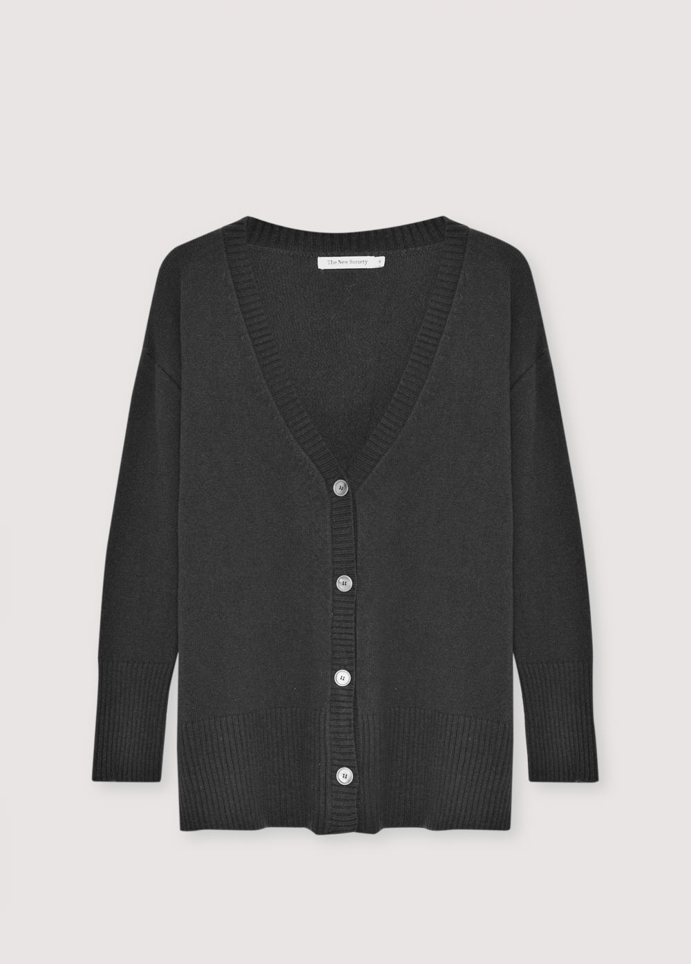 Oversized cashmere knit cardigan with tone-on-tone buttons.