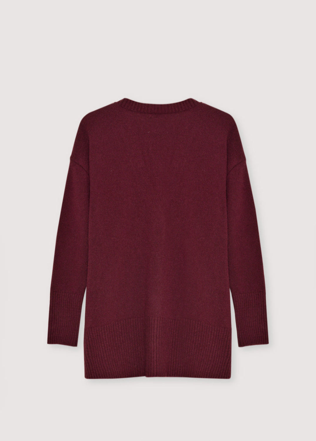 Maroon sweater on a light gray background