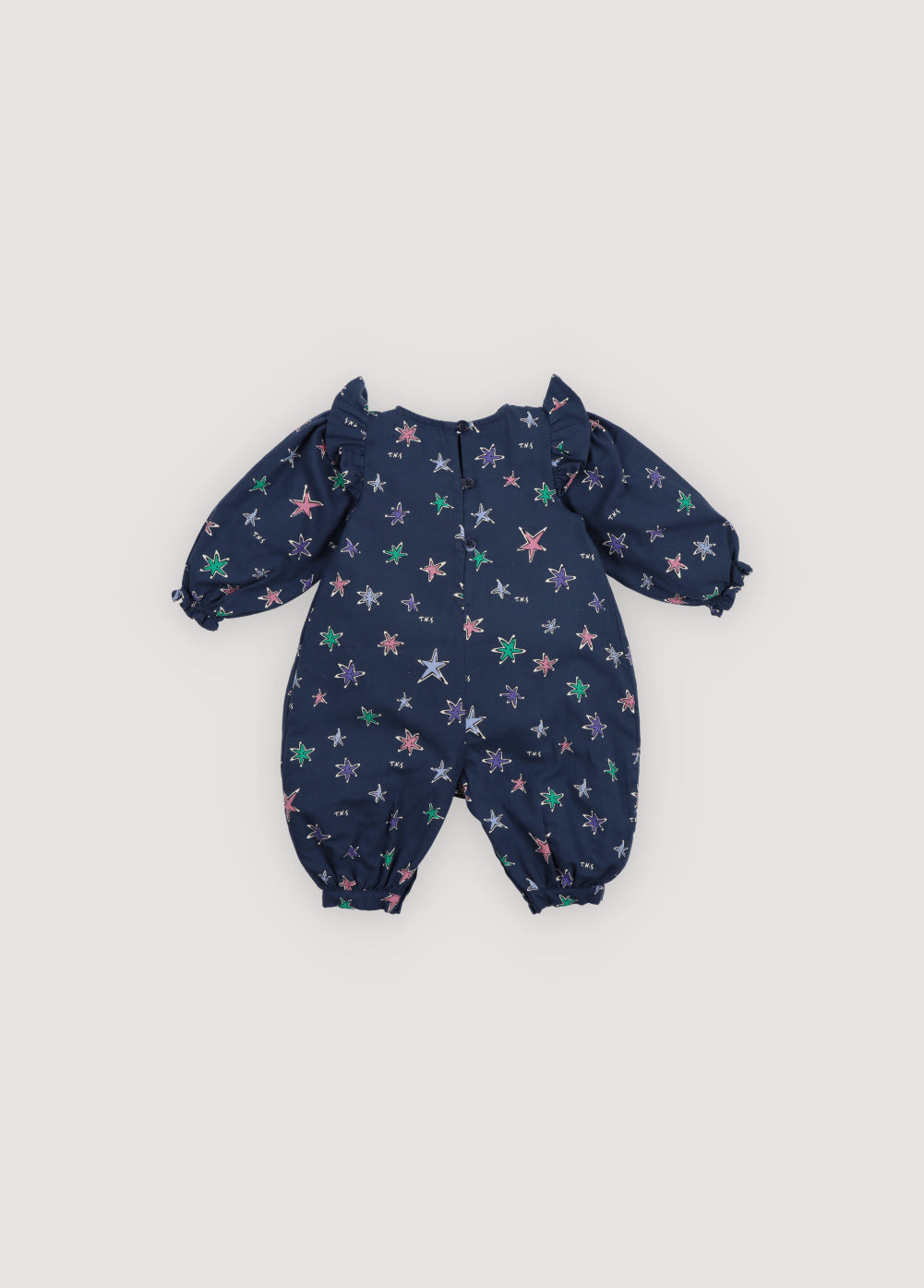 Flannel baby romper with a beautiful and colorful star print. It features pleat details at the front and ruffles on the shoulders. The back opening has tonal snap closures.
