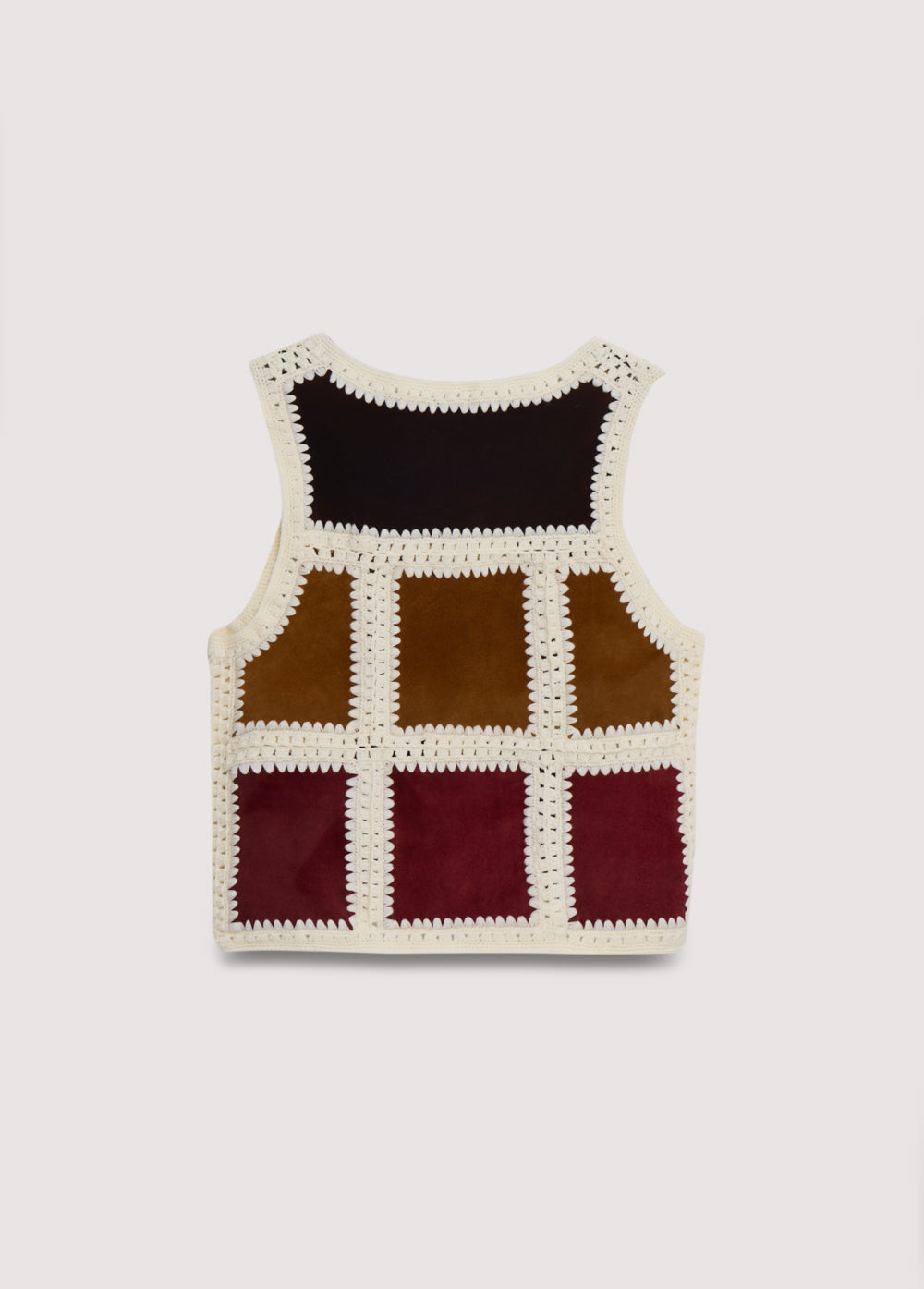 This vest is a special piece made in Spain, crafted from leather in various colors and handwoven wool crochet. A perfect piece to pair with the matching skirt.