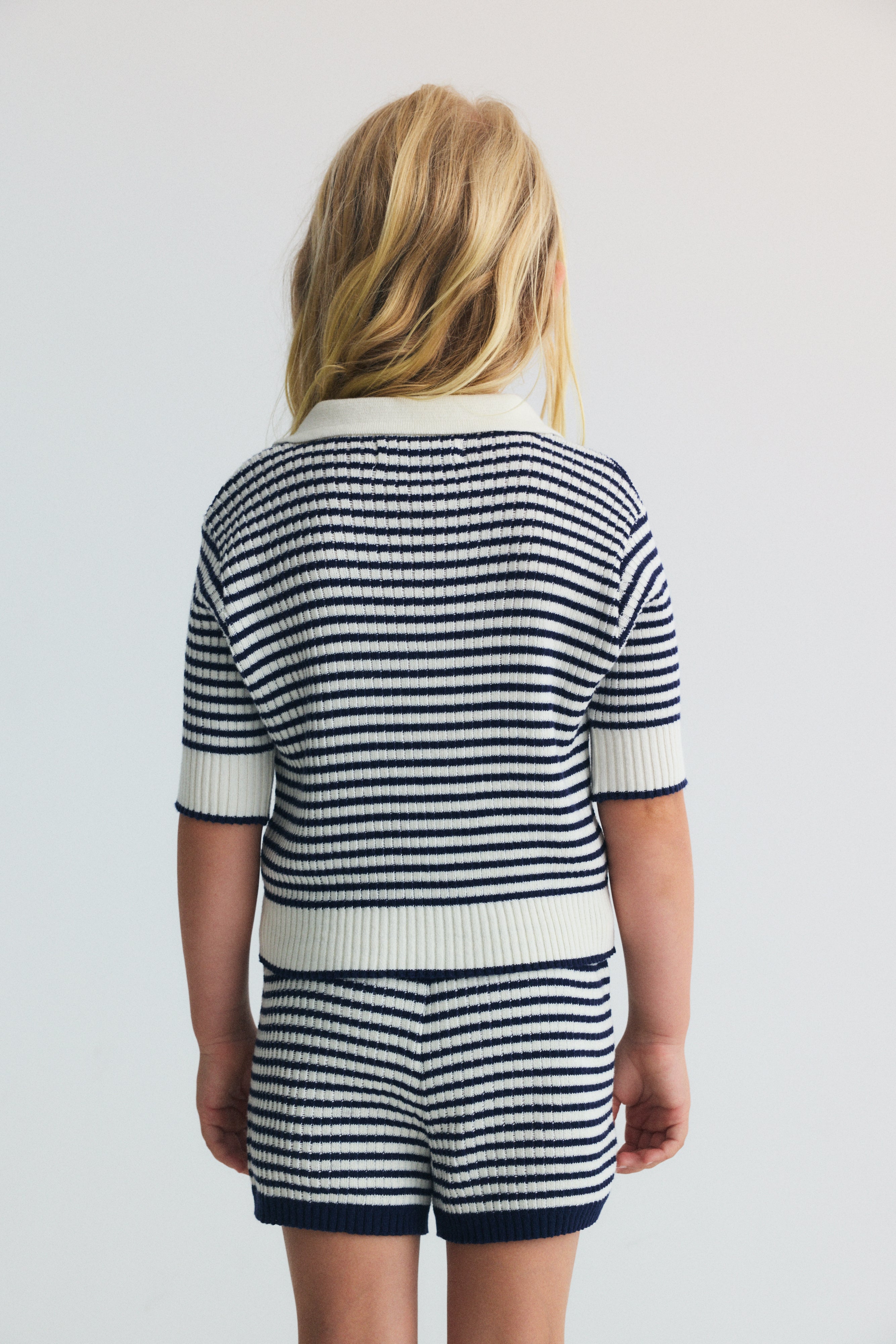 A lightweight knit polo with classic sailor style stripes and a subtle branded embroidery on the rib.