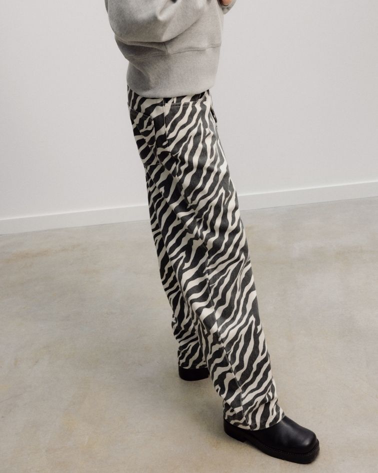 Crafted from 100% organic cotton, the TNS Denim Teen Barrel Trouser combines a distinctive barrel-leg silhouette with a playful all-over animal print, bringing character to an everyday denim essential.