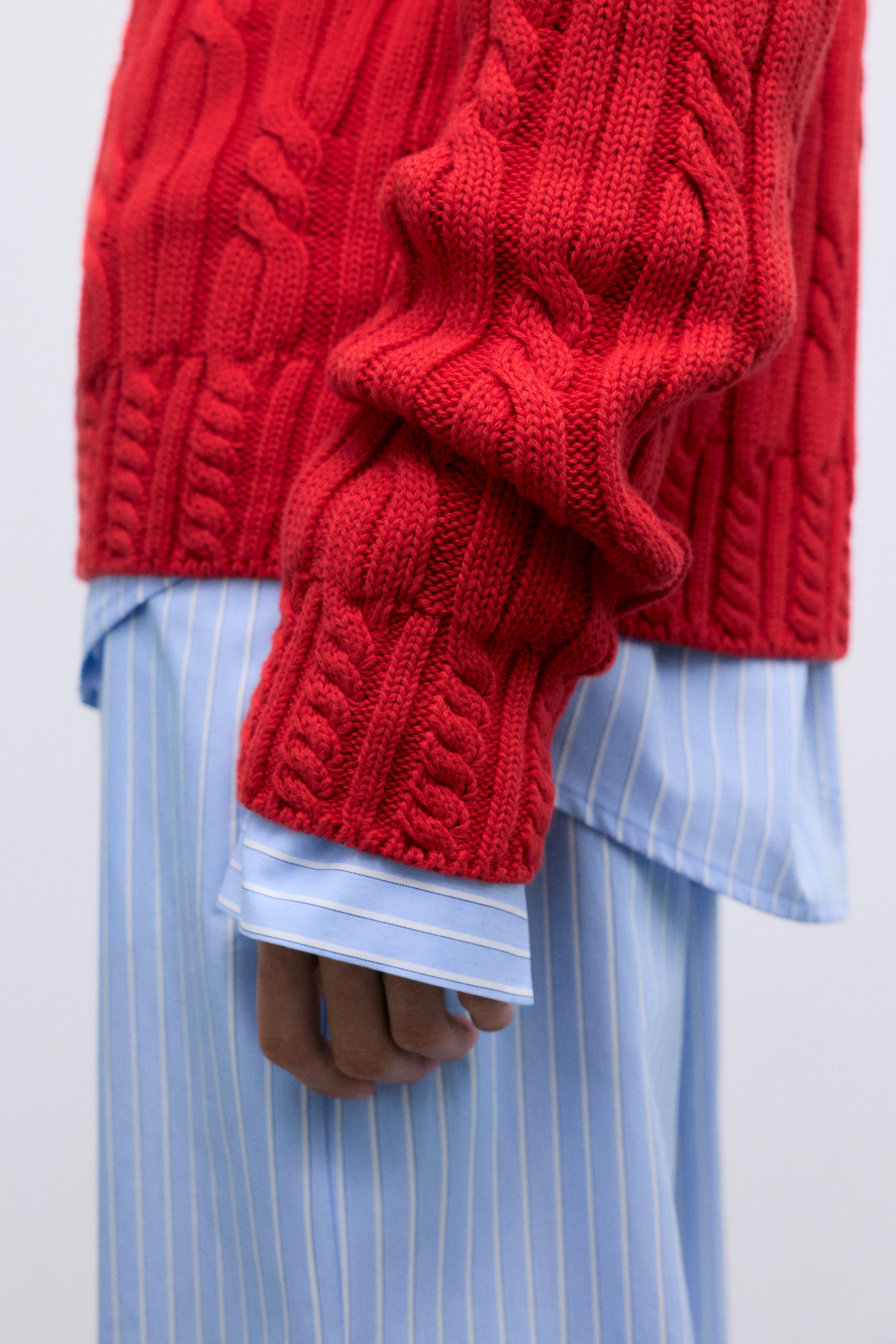 Cable knit sweater in soft cotton, featuring&nbsp;delicate cable details on the collar, cuffs, and hem. 