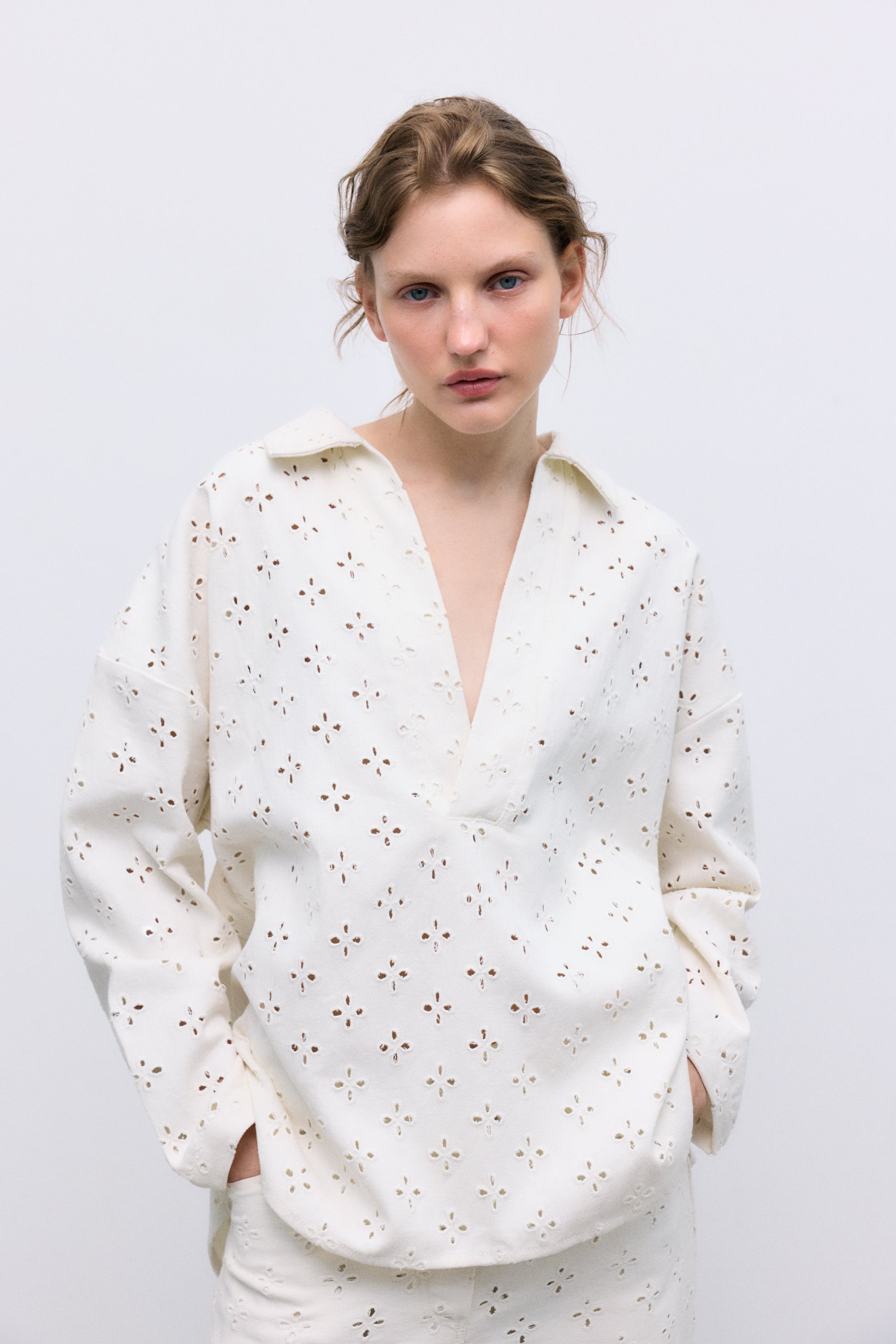 Polo-style blouse with a shirt collar and front opening, crafted from a delicate and special denim fabric featuring all-over embroidery for a unique textured finish
