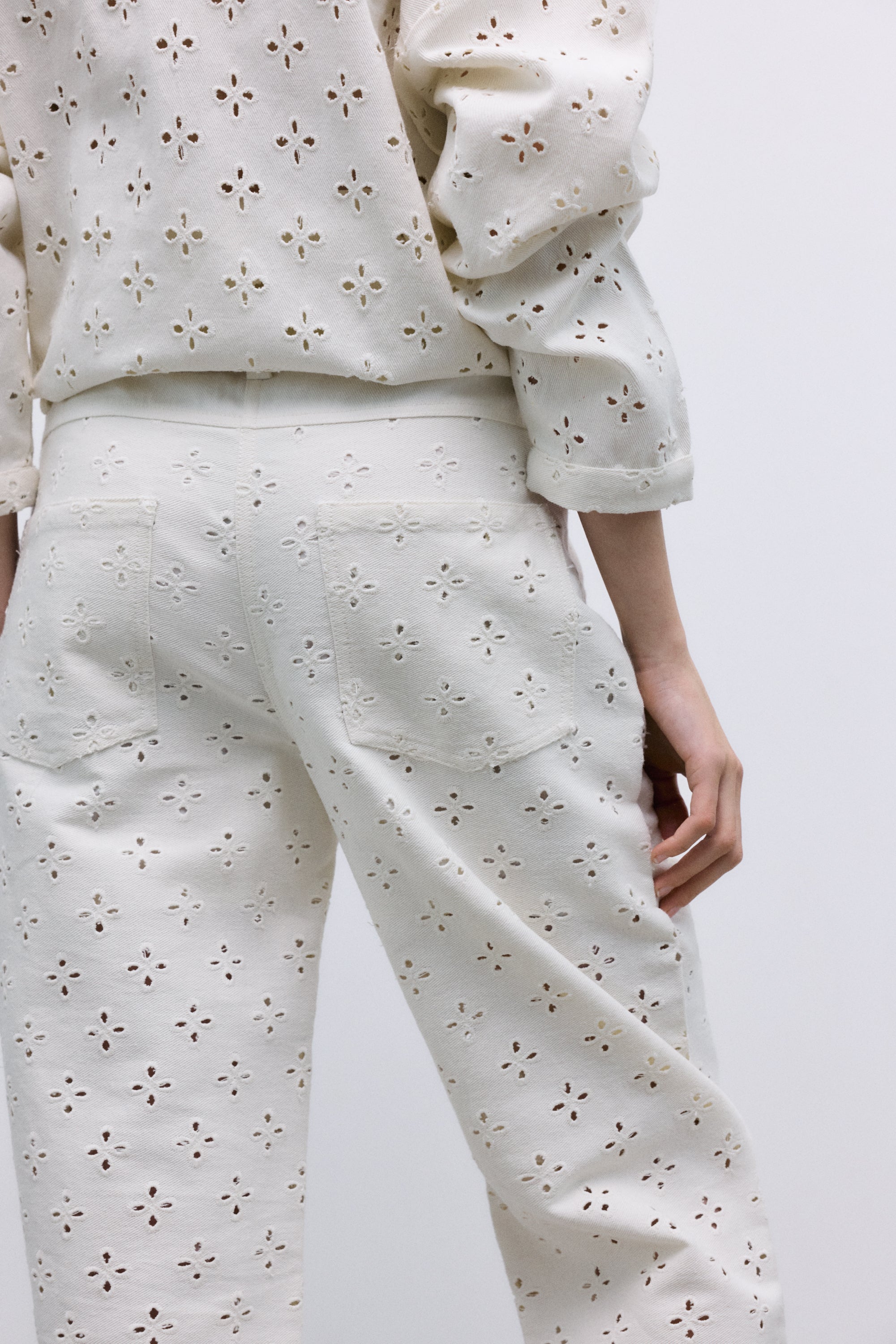 Polo-style blouse with a shirt collar and front opening, crafted from a delicate and special denim fabric featuring all-over embroidery for a unique textured finish