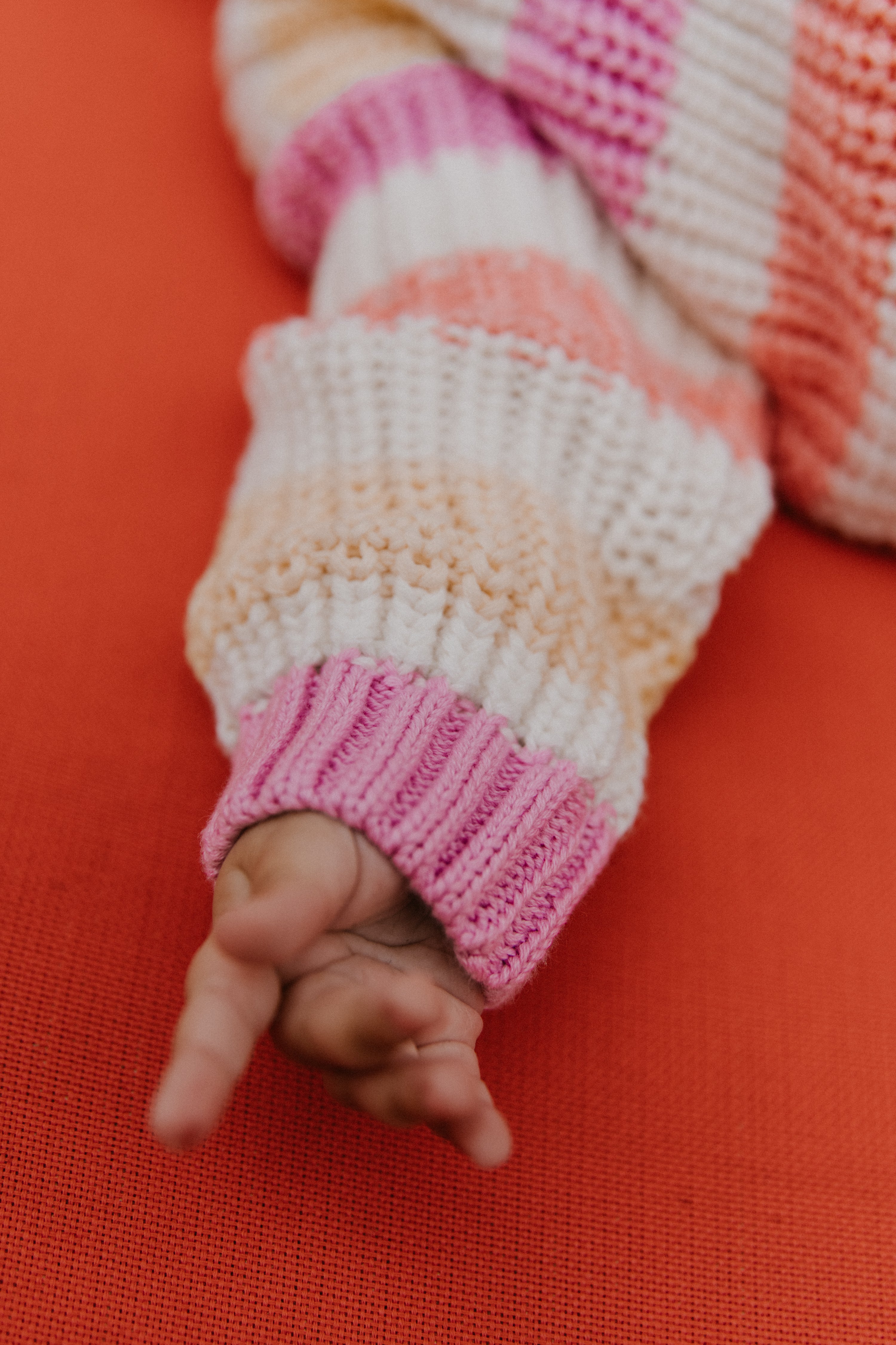 Baby striped cotton knit featuring fresh, summery colors and a charming embroidered logo detail on the chest