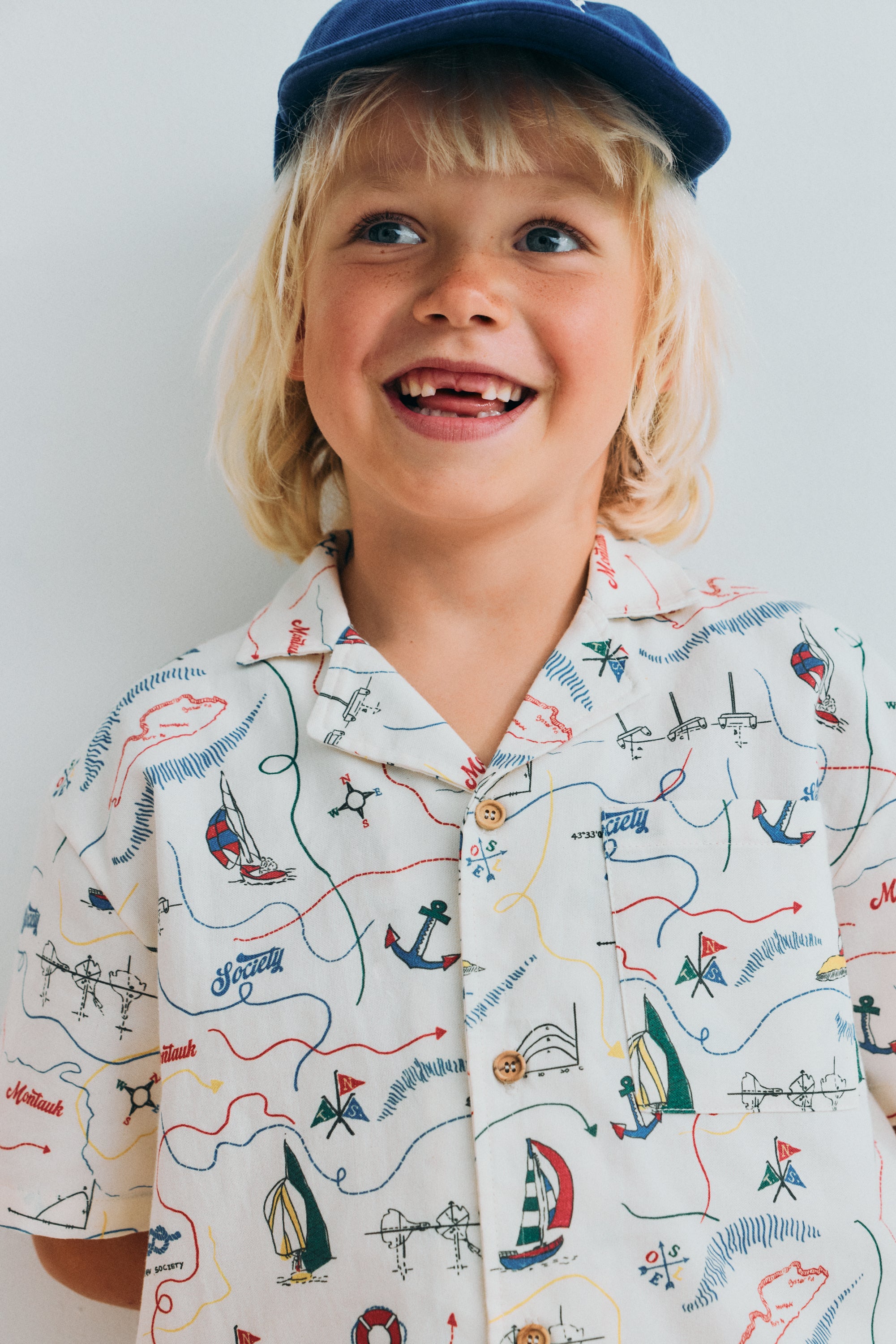 Short sleeve shirt in&nbsp;soft cotton featuring a unique multicolor map print and a front button closure with wooden buttons. 