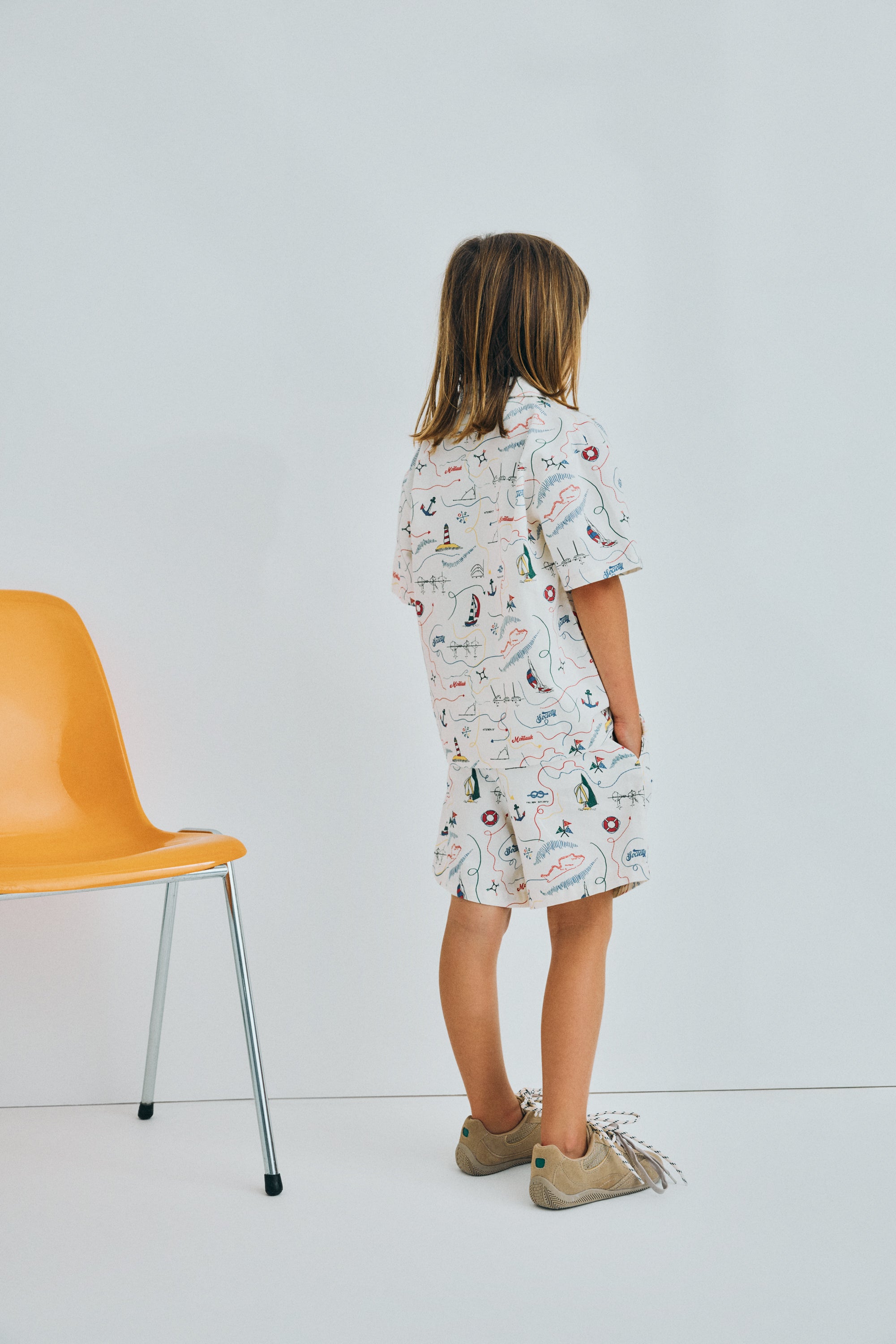 Short sleeve shirt in&nbsp;soft cotton featuring a unique multicolor map print and a front button closure with wooden buttons. 