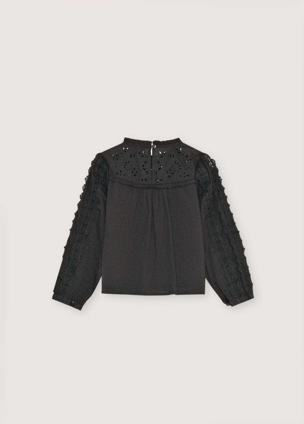 and lace detailing on the body and sleeves. It features a back keyhole opening with a tone-on-tone button. Perfect for pairing with the matching skirt.