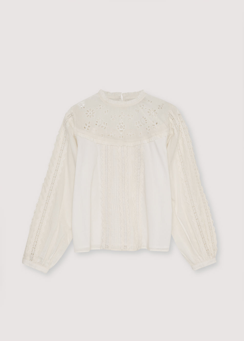 Cambric blouse with embroidered yoke detail and ruffles, and lace detailing on the body and sleeves. It features a back keyhole opening with a tone-on-tone button.