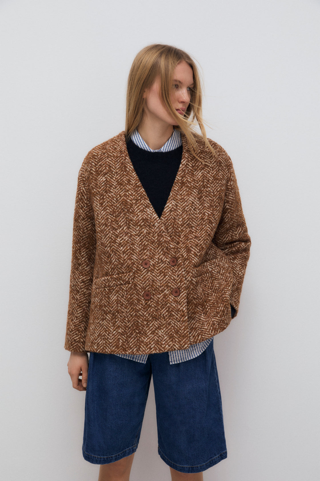 A double-breasted wool blazer with four buttons and pockets.