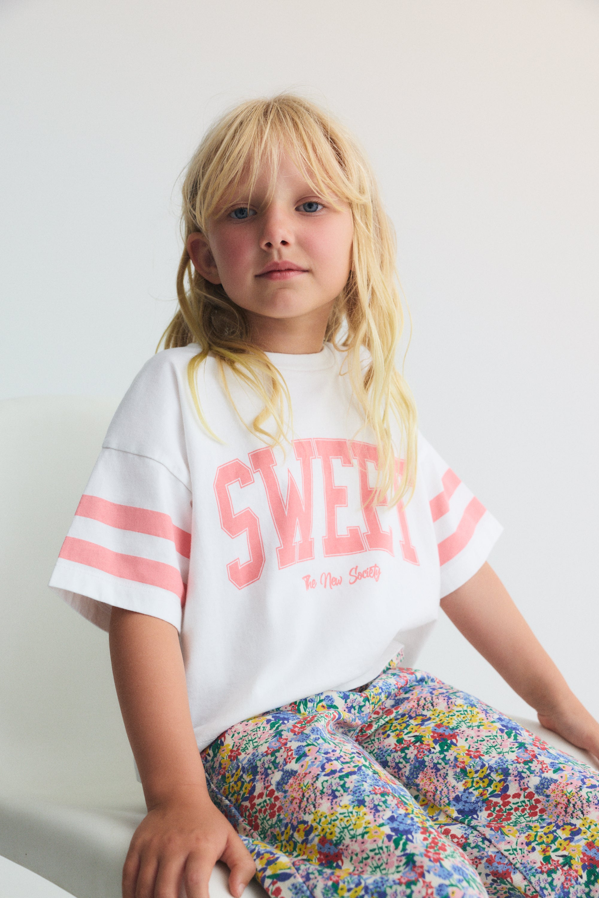 Soft cotton jersey crop tee featuring contrast prints on the sleeves and a “Sweet” print on the front for a playful, modern look.