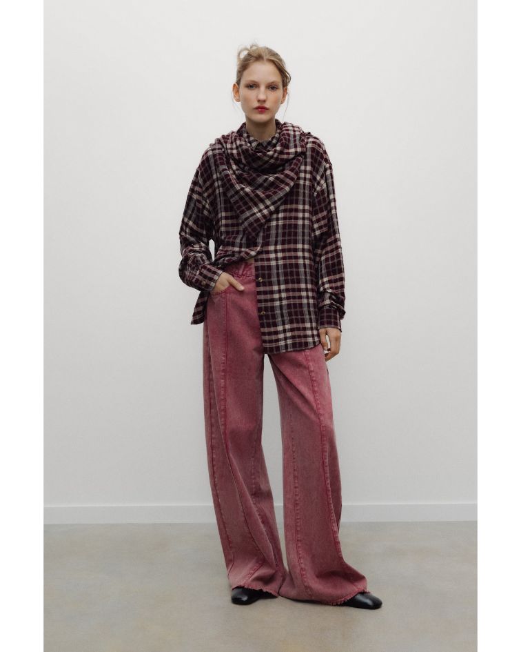 The Ember Woman Shirt is a timeless wardrobe essential, defined by its relaxed silhouette and refined tailoring