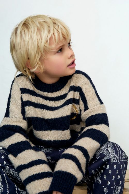 Child wearing The New Society Jorge Jumper in Infinite Navy — classic two-tone striped wool blend with chest embroidery.