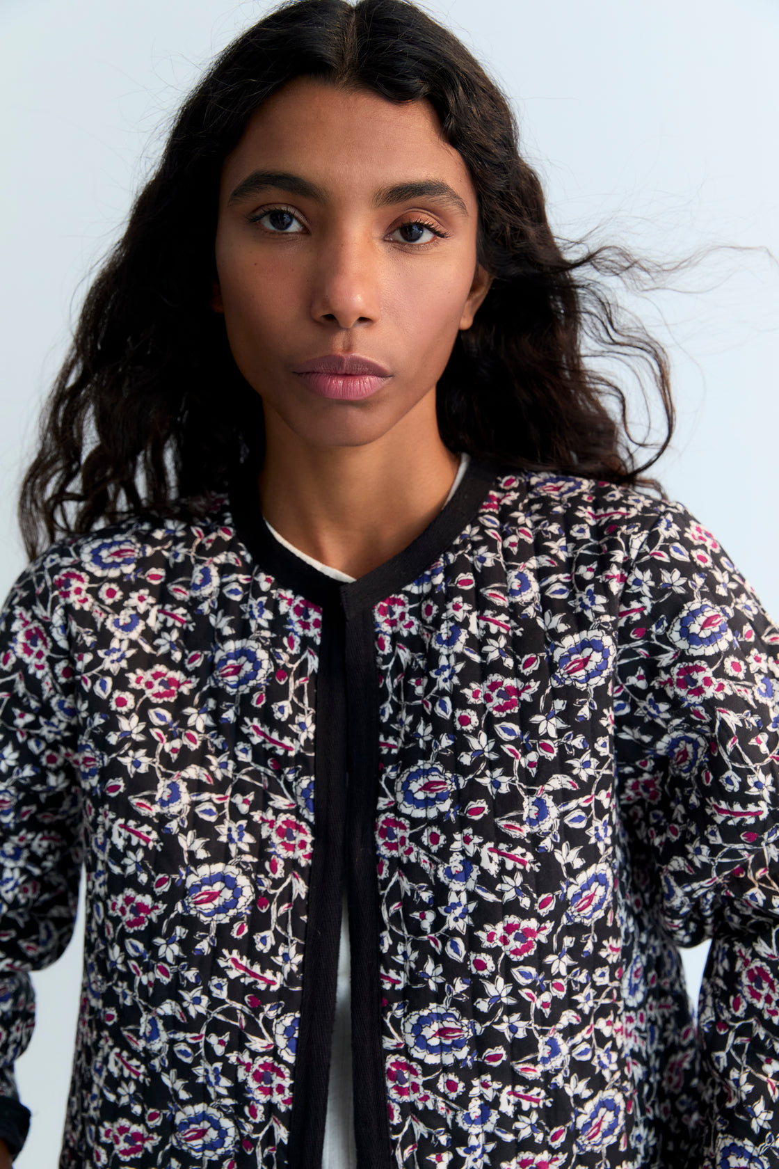 Quilted cropped jacket with a beautiful print design and finishes with a herringbone tape in tone. 