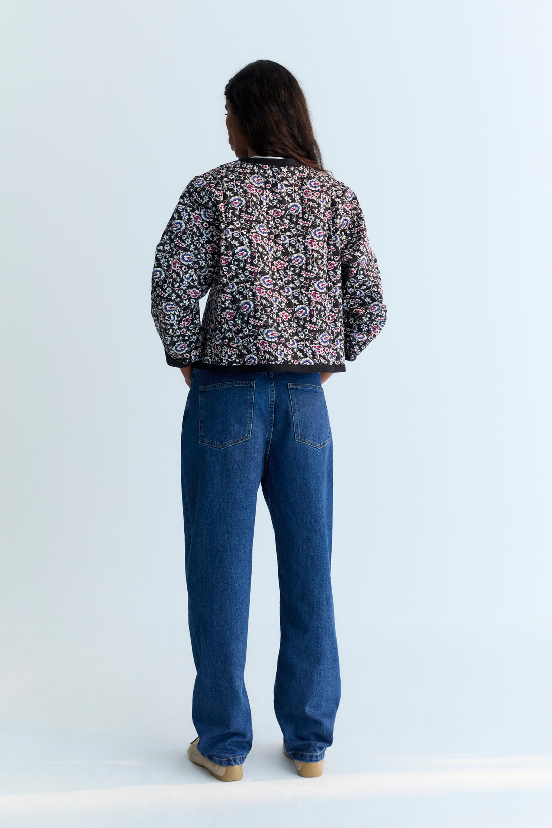 Quilted cropped jacket with a beautiful print design and finishes with a herringbone tape in tone. 