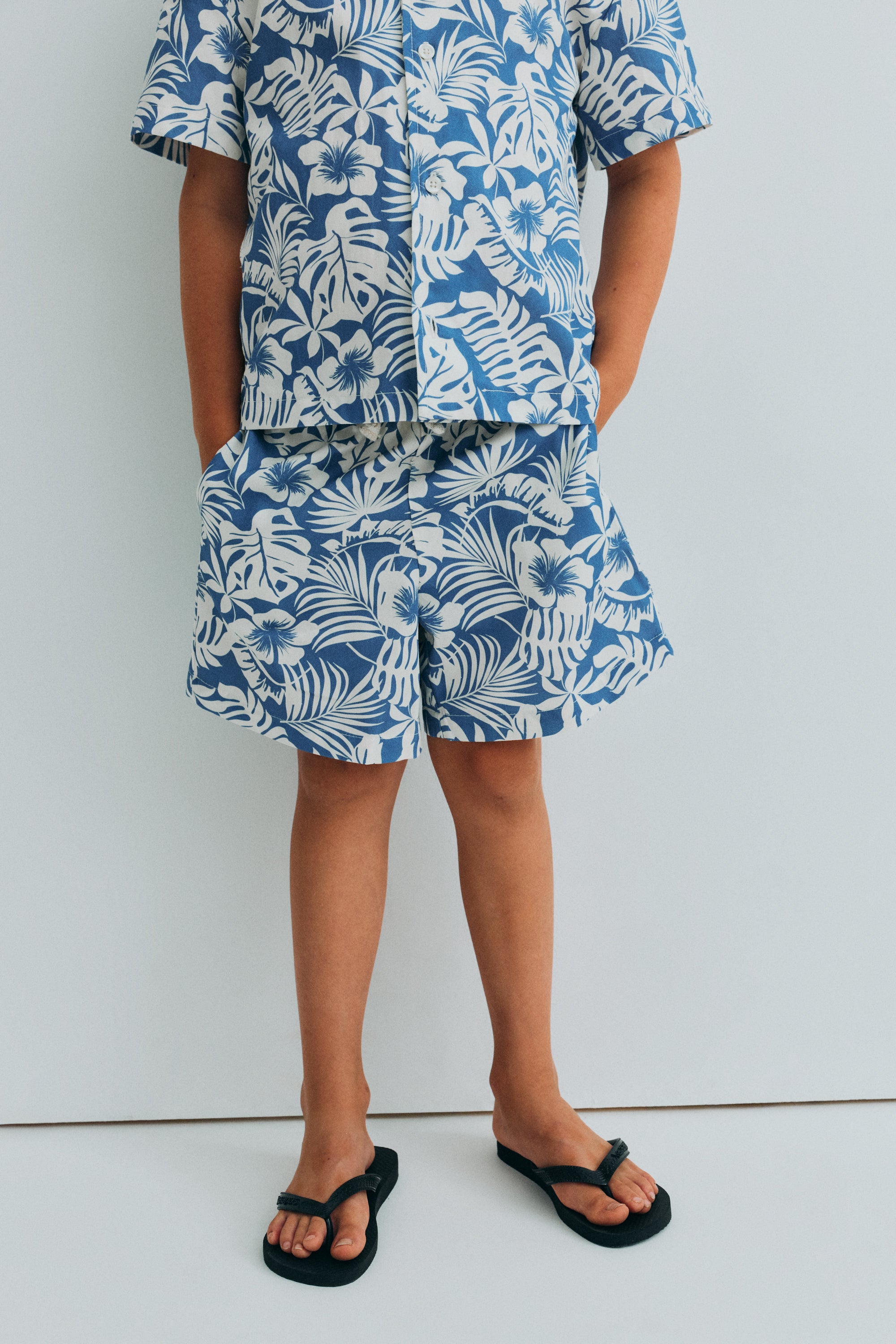 This short-sleeve shirt for kids is crafted from soft, breathable cotton, designed to keep little ones comfortable throughout the warmer days.