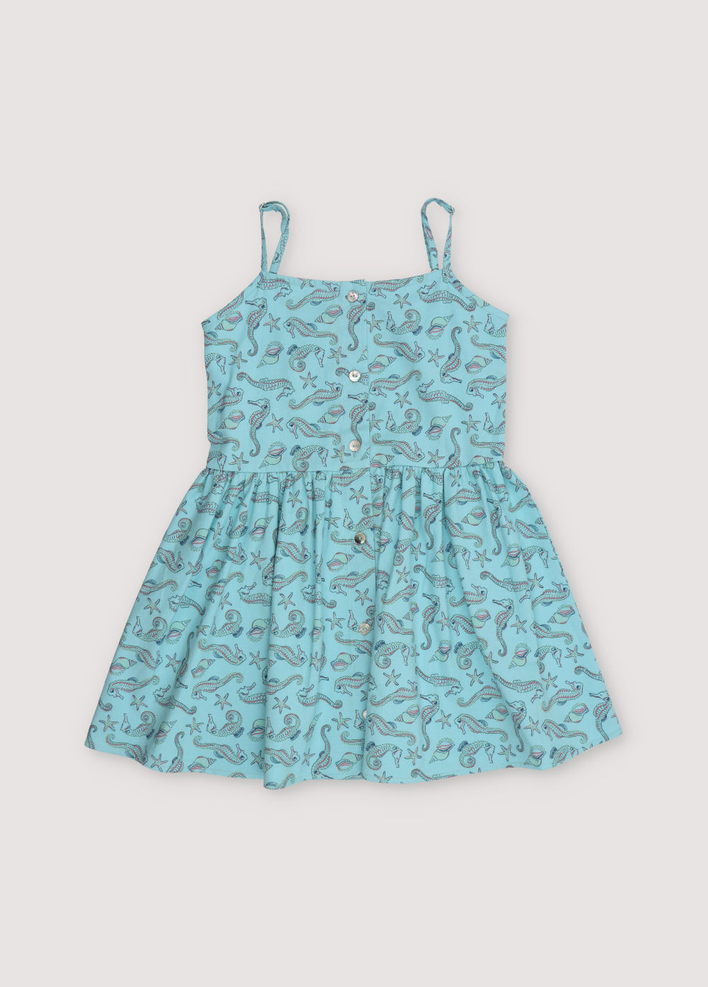 Io Dress in 100% cotton fabric with our seahorses print, featuring straps, a waist cut, voluminous skirt, and central front buttons.
