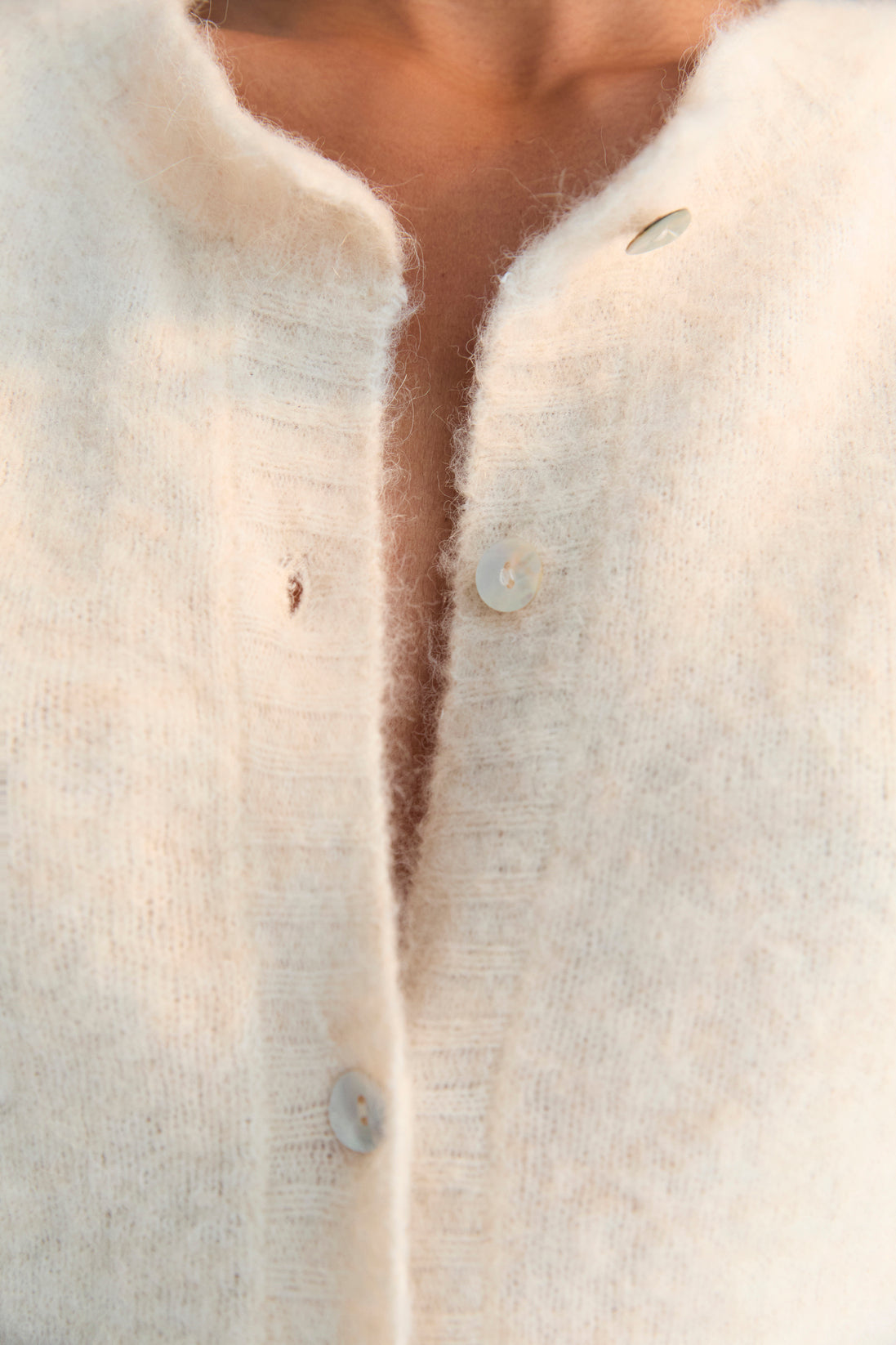 Alpaca and merino wool knit cardigan with a mother-of-pearl button closure.