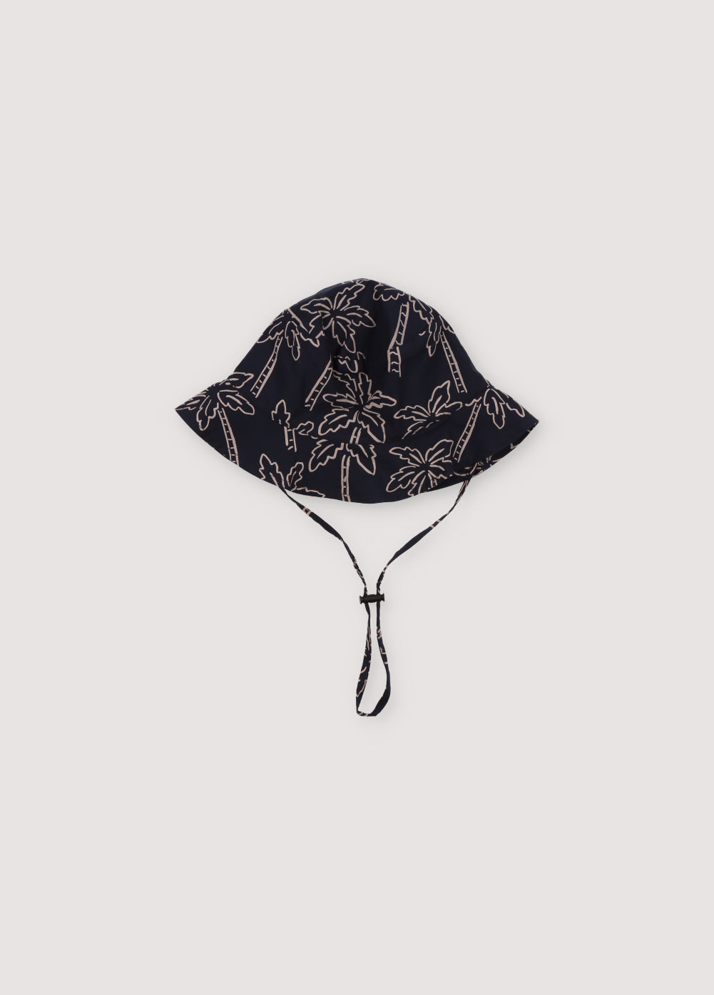 Ithaki Baby Hat in 100% cotton fabric with our Palms Navy print, featuring a navy cord detail with matching stopper. Spring Summer Collection. The New Society.